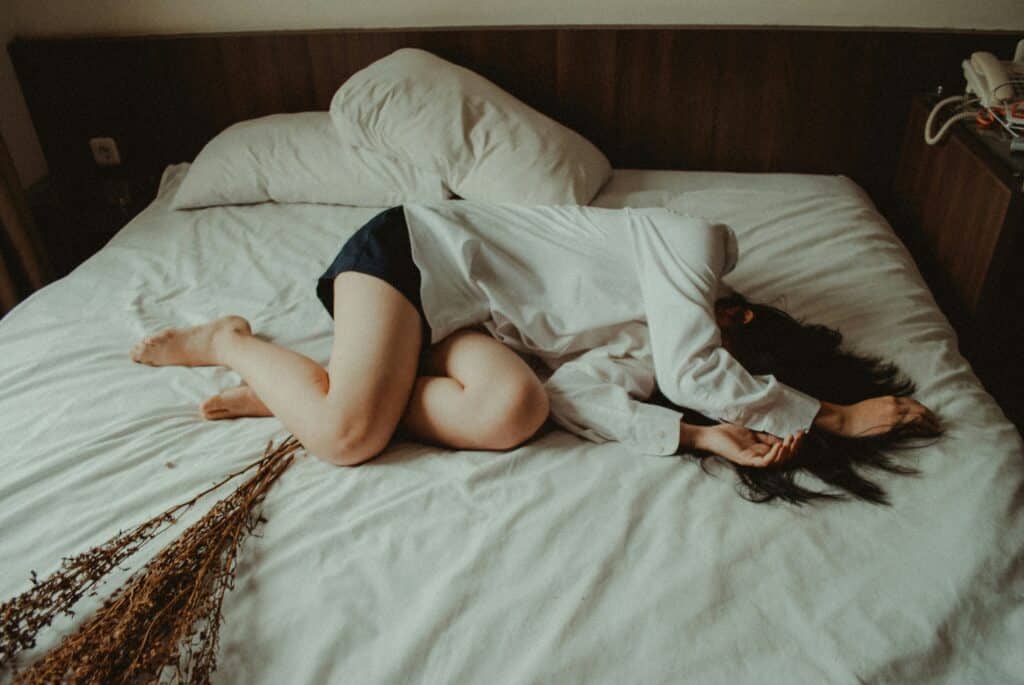 a woman in bed with stomach pain