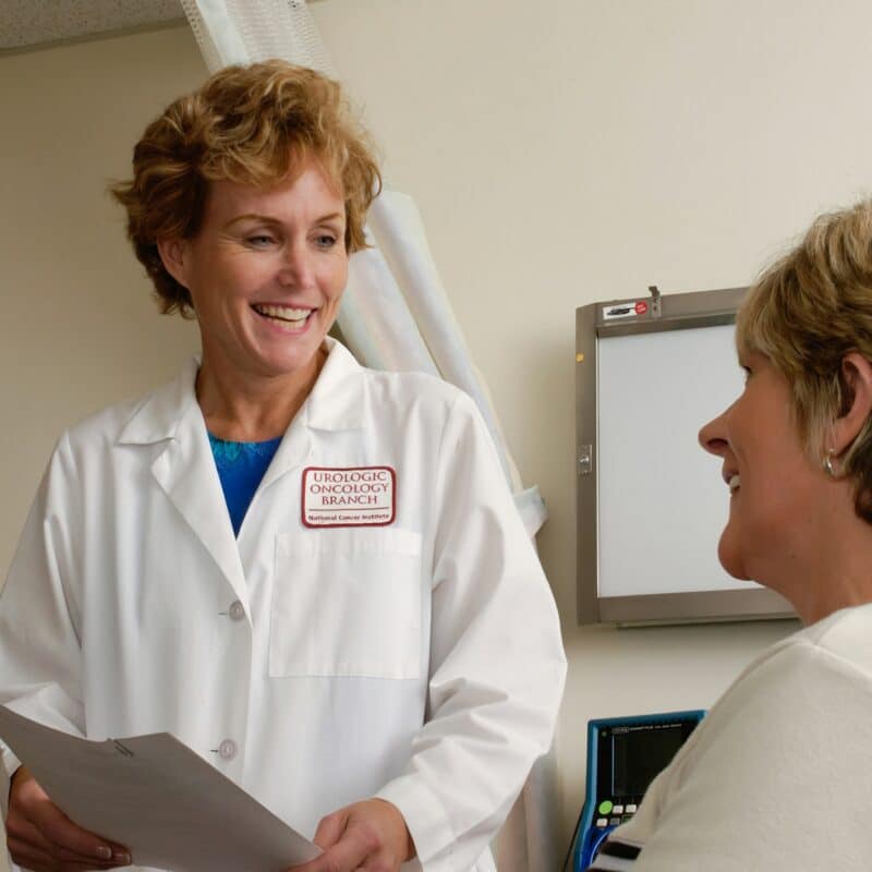 A healthcare professional talking to a patient, demonstrating the importance of support and communication, which can also include guidance on finding financial aid resources for endometriosis treatment.