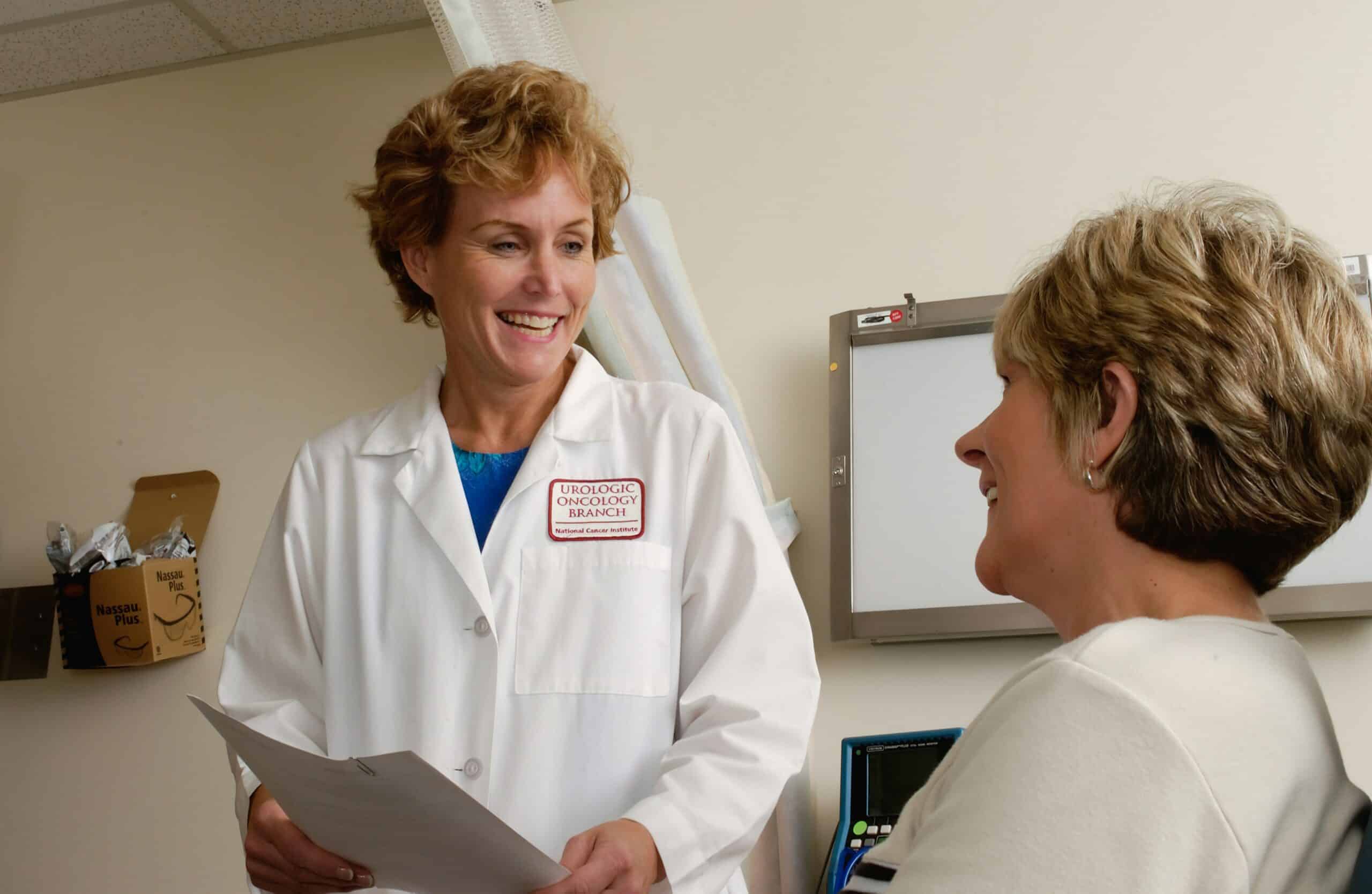 A healthcare professional talking to a patient, demonstrating the importance of support and communication, which can also include guidance on finding financial aid resources for endometriosis treatment.