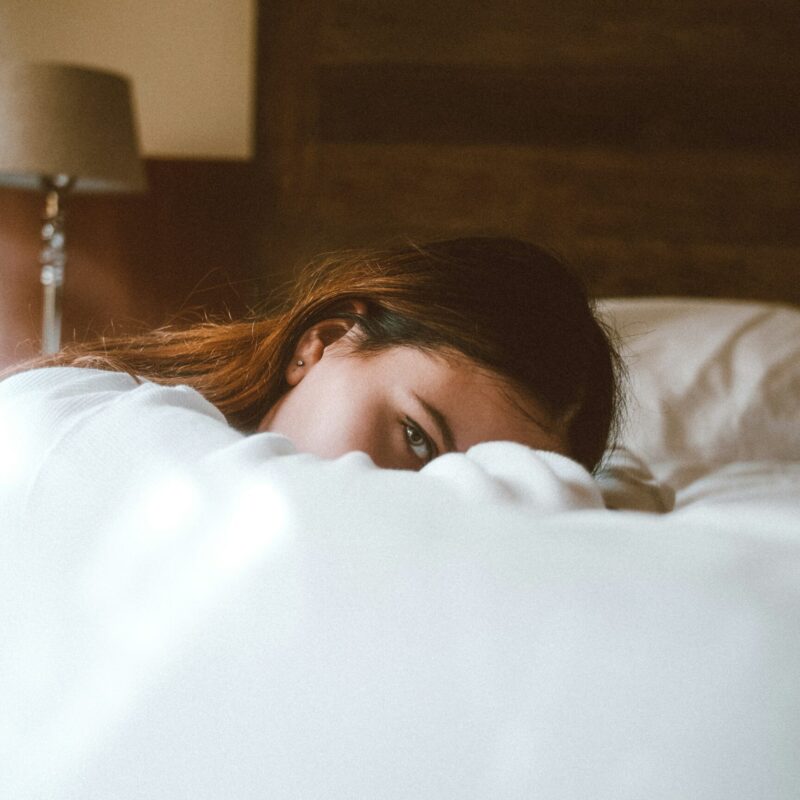 a woman resting on a bed