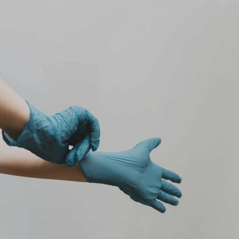 a doctor putting on gloves