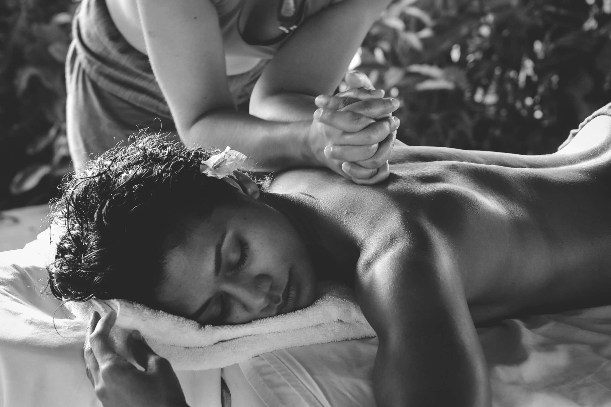 A person receiving a therapeutic massage, which could provide relief from muscle tension and stress, potentially alleviating some symptoms associated with endometriosis.