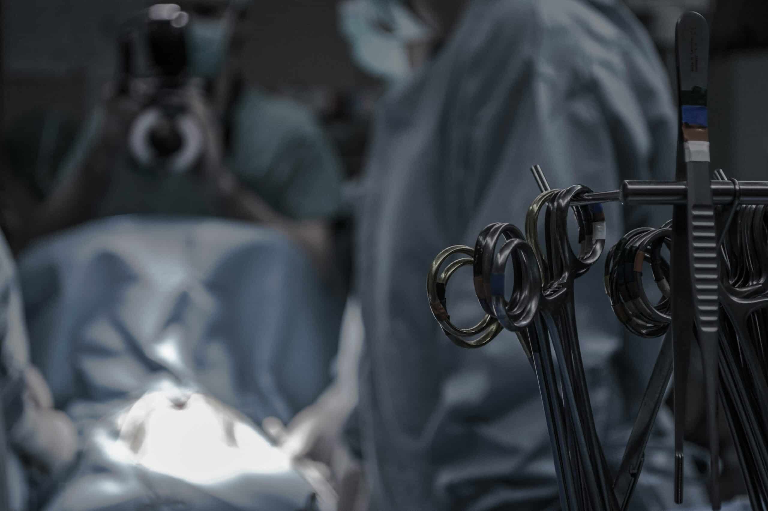 A surgical team prepares for an operation with instruments in focus, illustrating the role of surgical interventions in managing endometriosis-related fertility challenges. - Rachael Haverland Site A surgical setting with medical instruments and a team performing a procedure representing the evaluation of different surgical options for endometriosis.