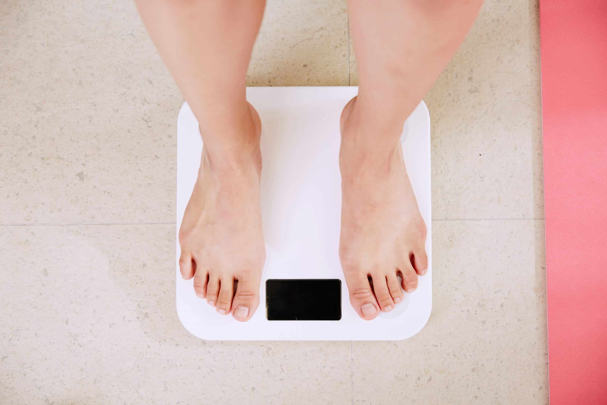 A person standing on a digital weighing scale, reflecting factors like weight in assessing surgical risks. - Rachael Haverland Site A person standing on a digital weighing scale, reflecting factors like weight in assessing surgical risks.