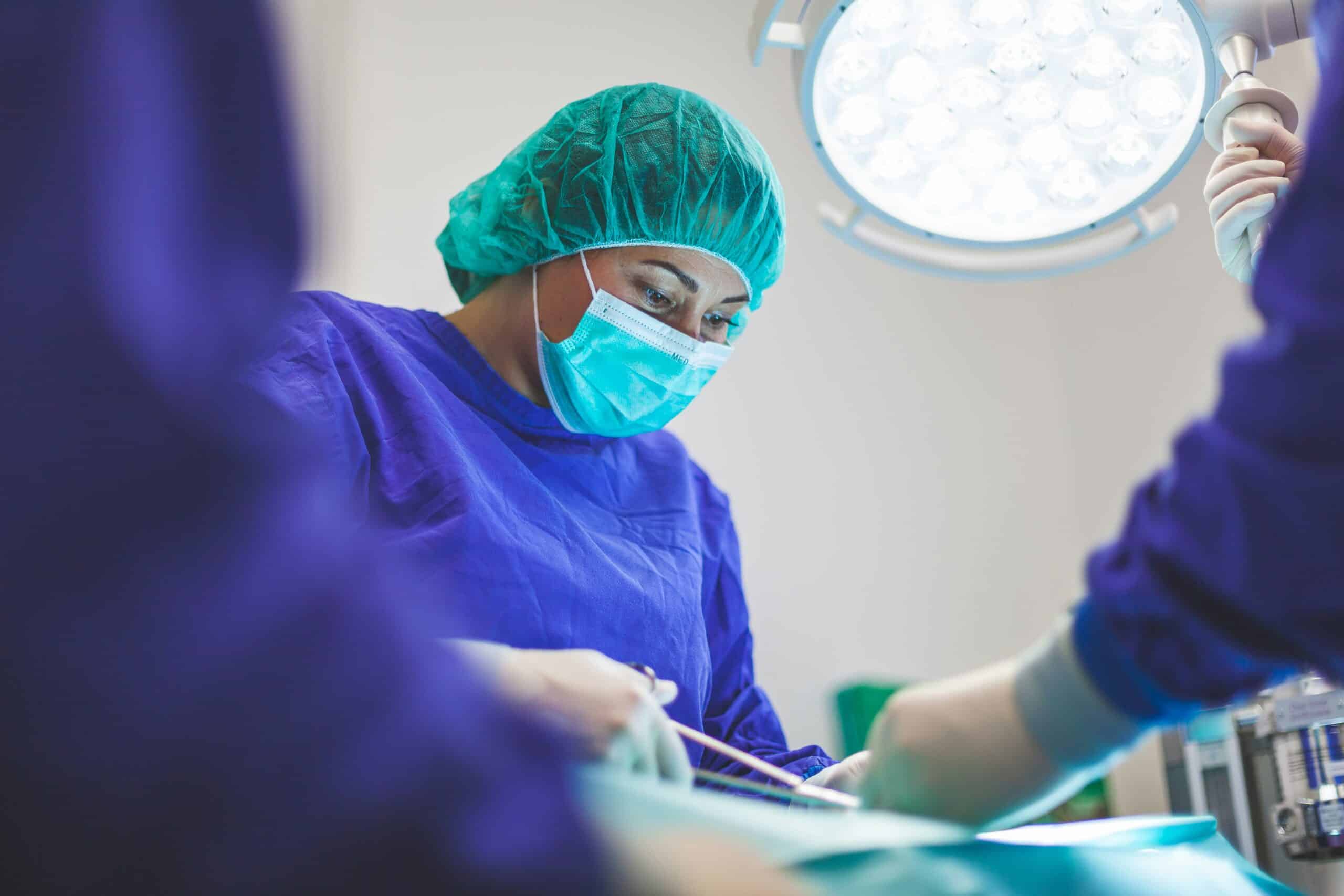 A surgeon in an operating room performing a procedure, representing the process of surgical treatment for endometriosis, including excision surgery and hysterectomy as potential options. - Rachael Haverland Site A surgeon in an operating room performing a procedure, representing the process of surgical treatment for endometriosis, including excision surgery and hysterectomy as potential options.