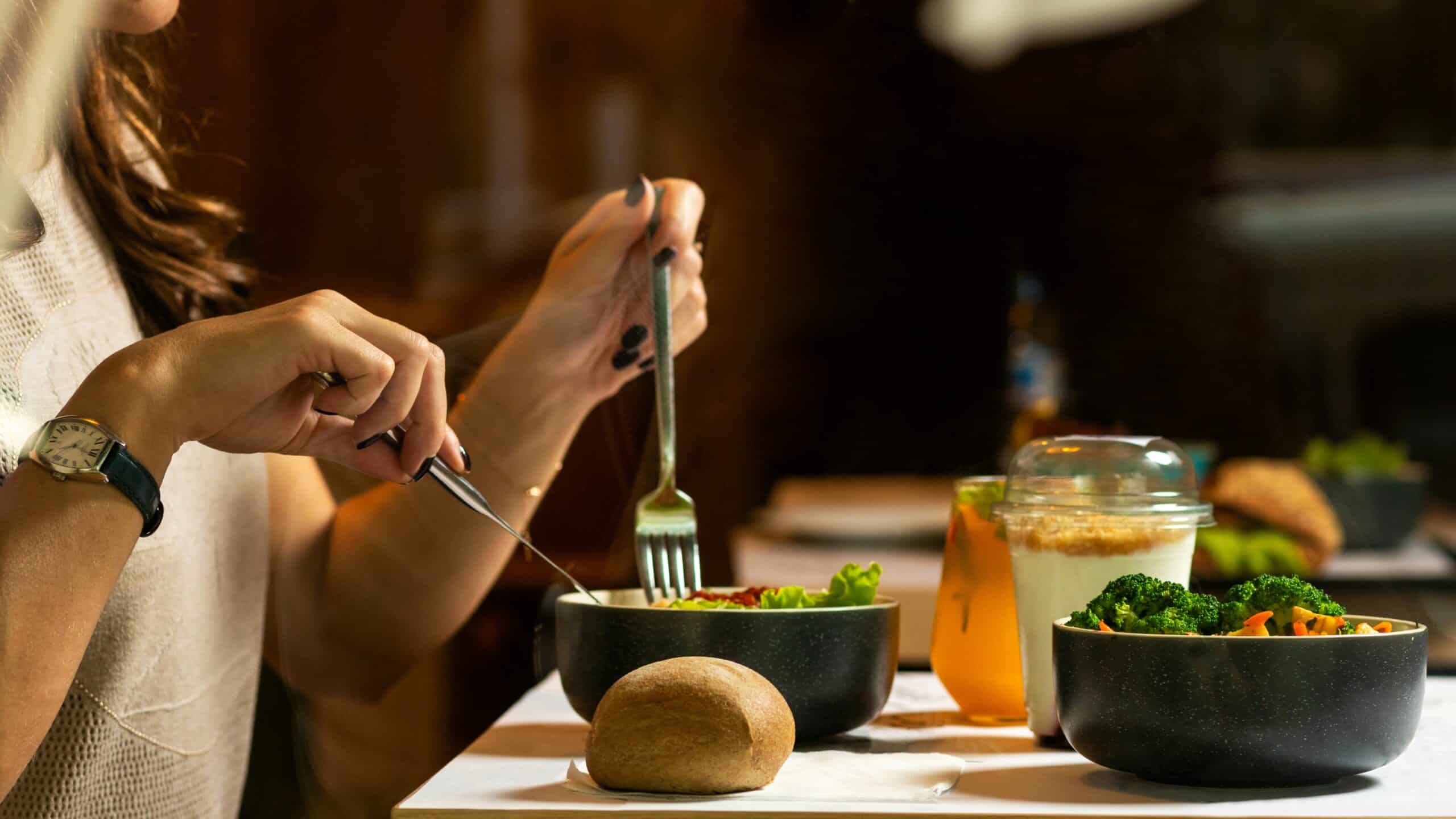 A woman enjoying a nutrient-rich meal, including broccoli and salad, highlighting the role of dietary choices—such as soy intake—in managing endometriosis symptoms. - Rachael Haverland Site A woman enjoying a nutrient-rich meal, including broccoli and salad, highlighting the role of dietary choices—such as soy intake—in managing endometriosis symptoms.