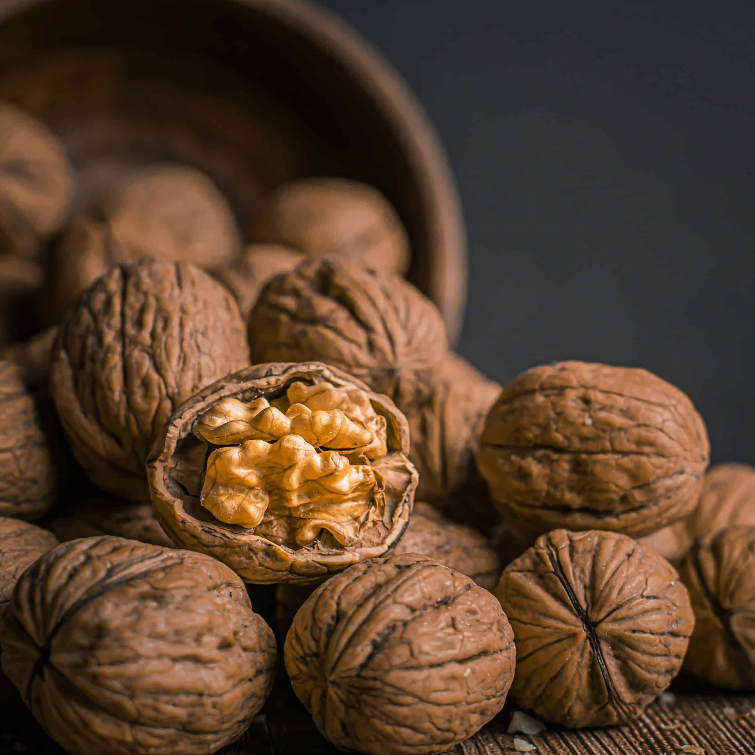 A close-up of whole and cracked walnuts, showcasing a natural source of omega-3 fatty acids and the benefits of incorporating them into a healthy diet.