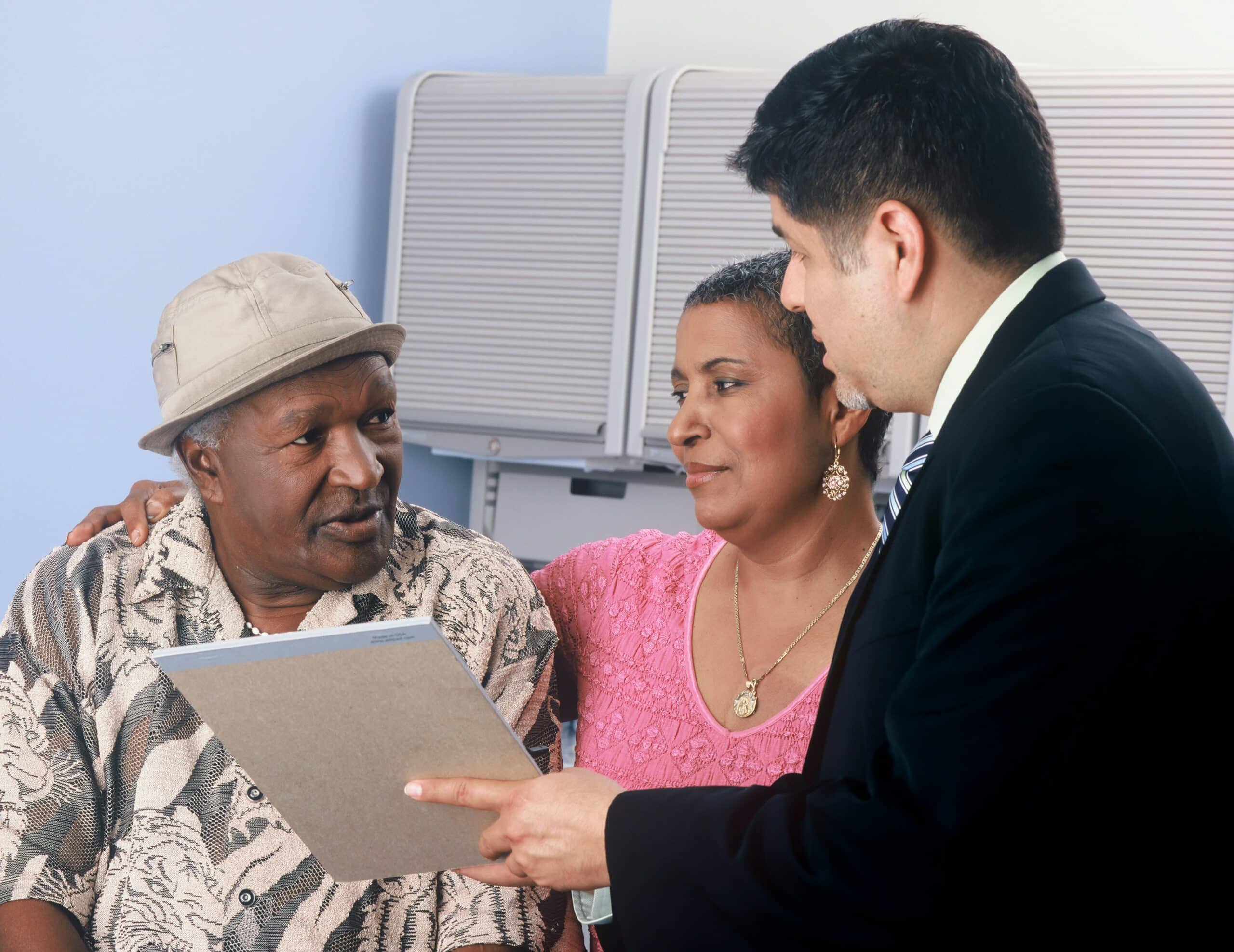 A doctor explaining medical information to a couple, representing the process of understanding hysterectomy as a treatment for endometriosis. - Rachael Haverland Site A doctor explaining medical information to a couple, representing the process of understanding hysterectomy as a treatment for endometriosis.