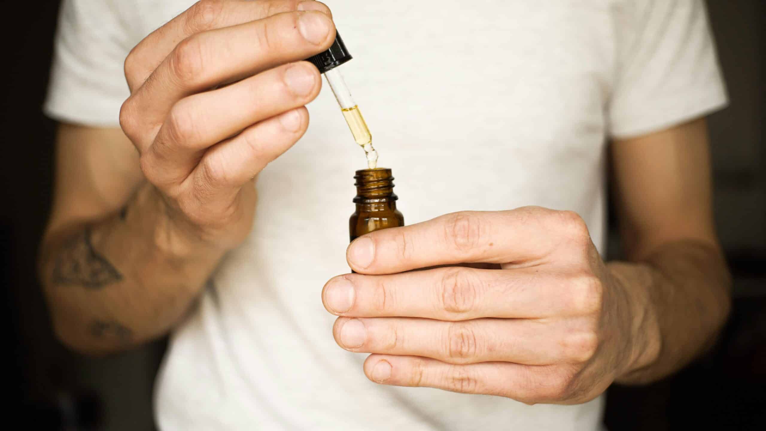 a person holding CBD oil - Rachael Haverland Site a person holding CBD oil