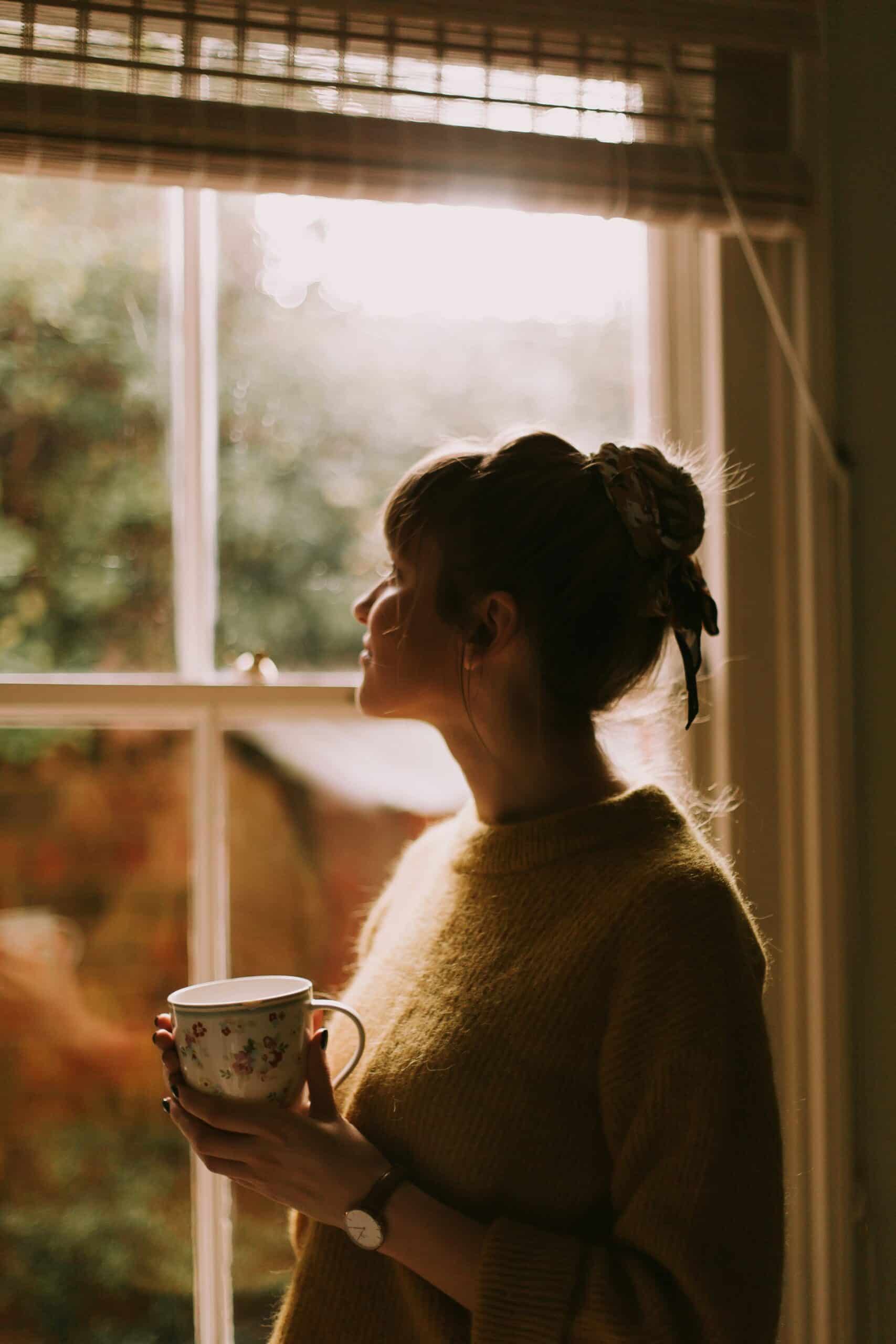 woman looking out the window