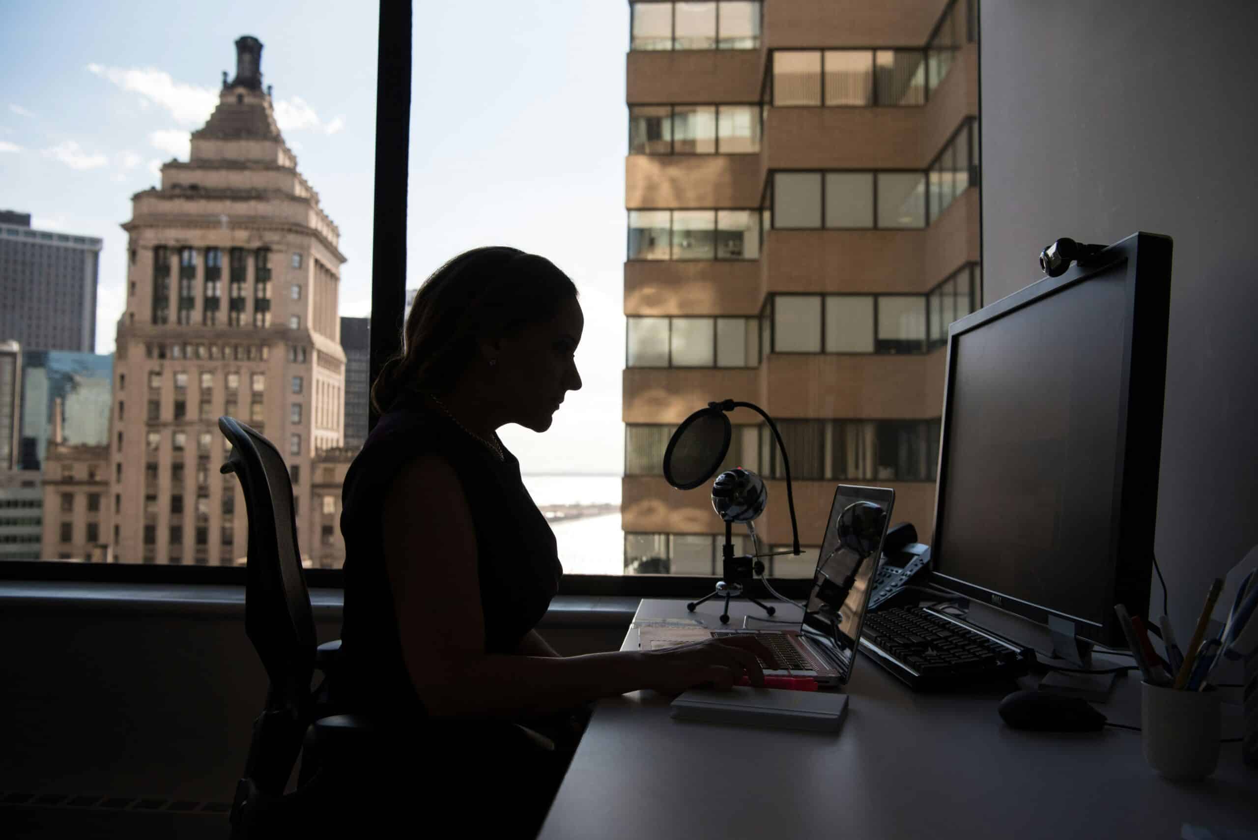 Professional woman managing endometriosis symptoms while working in an office - Rachael Haverland Site Professional woman managing endometriosis symptoms while working in an office