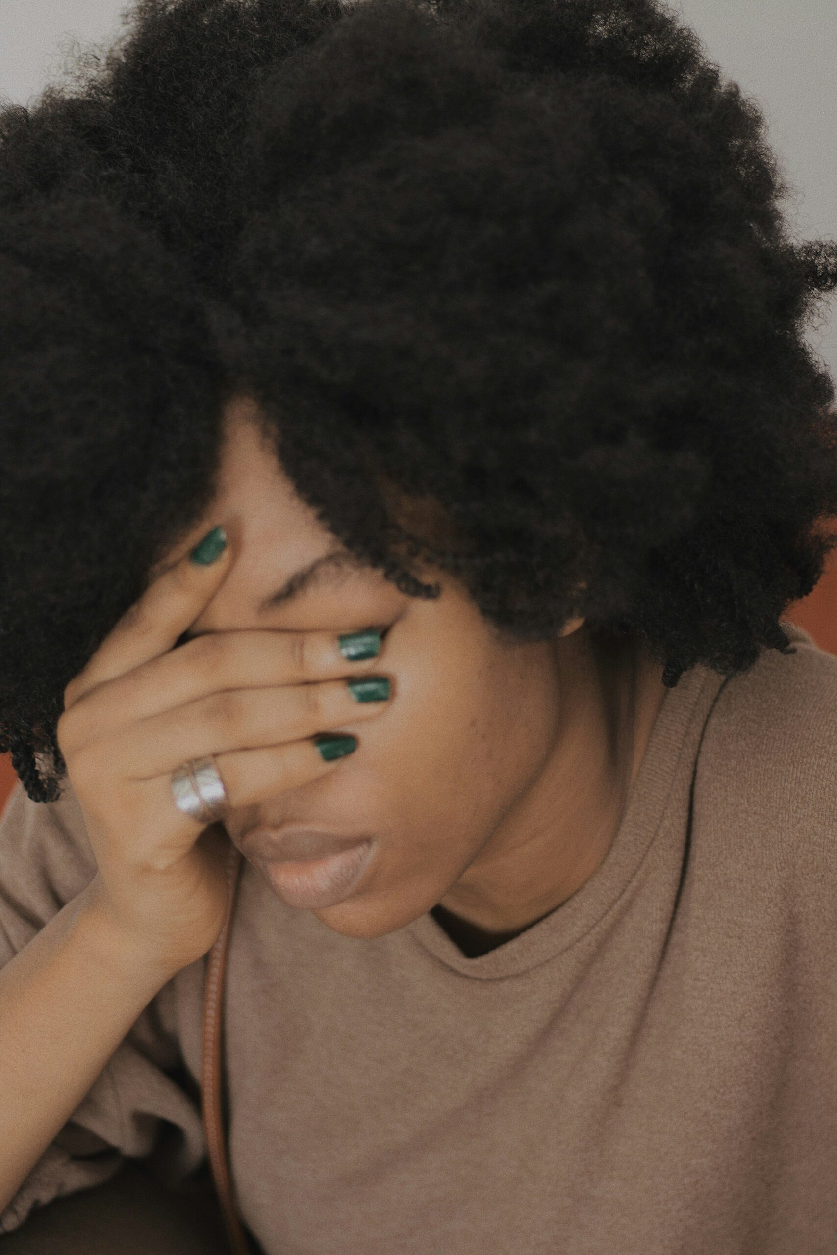 A person rests their hand over their face in emotional distress, highlighting the need for strong support systems during fertility struggles. - Rachael Haverland Site A person rests their hand over their face in emotional distress, highlighting the need for strong support systems during fertility struggles.