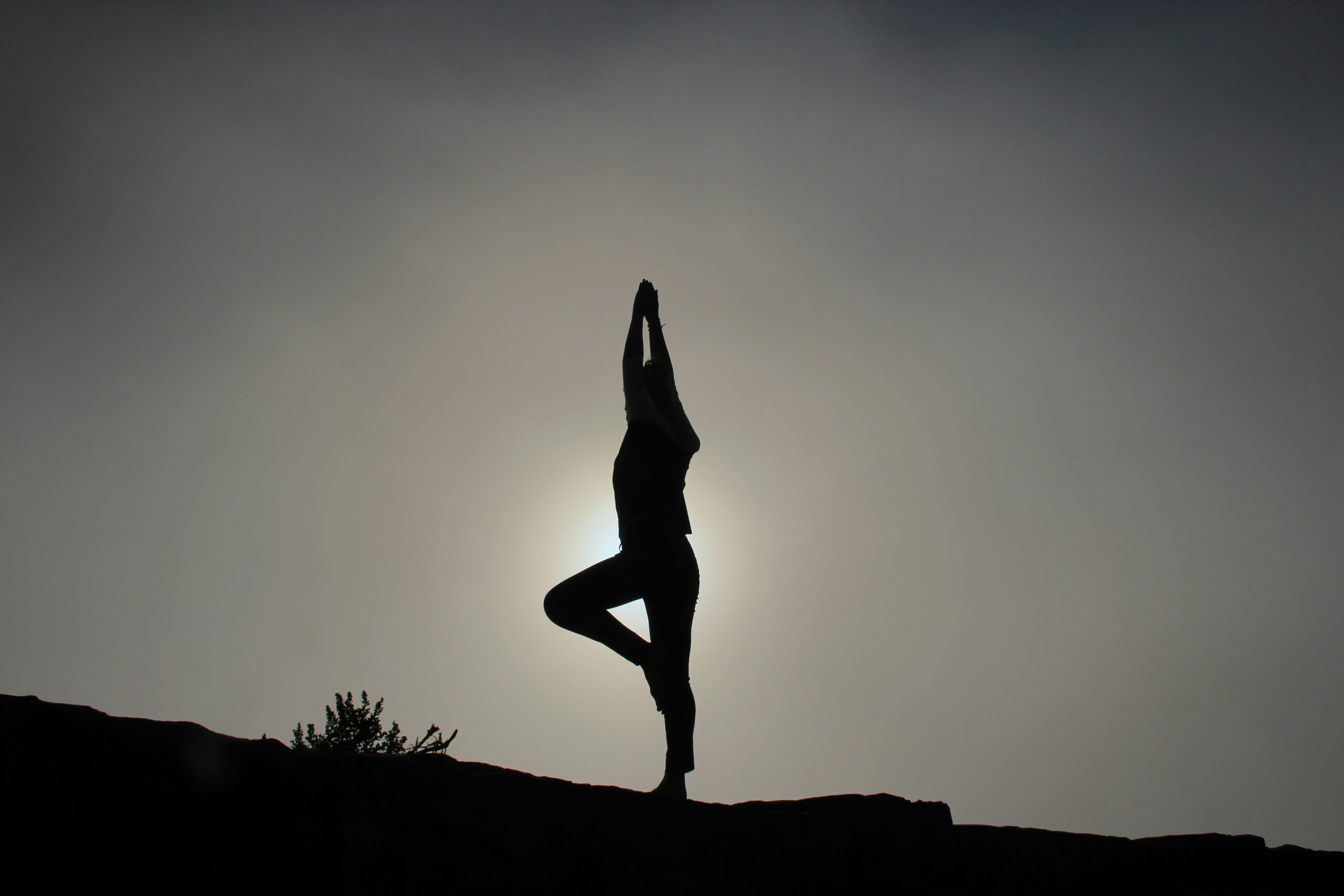 a woman practicing yoga on a hill - Rachael Haverland Site a woman practicing yoga on a hill