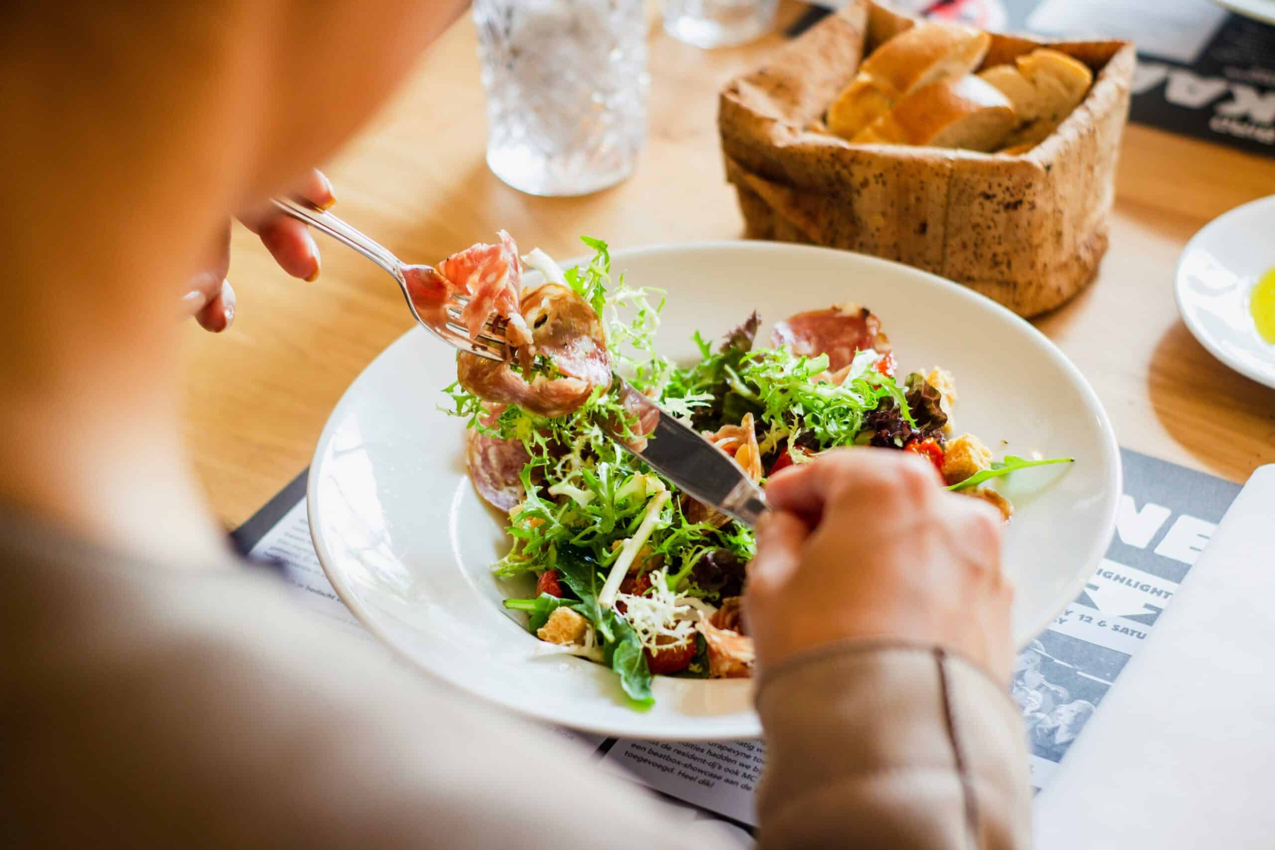 a woman eating a healthy salad - Rachael Haverland Site a woman eating a healthy salad