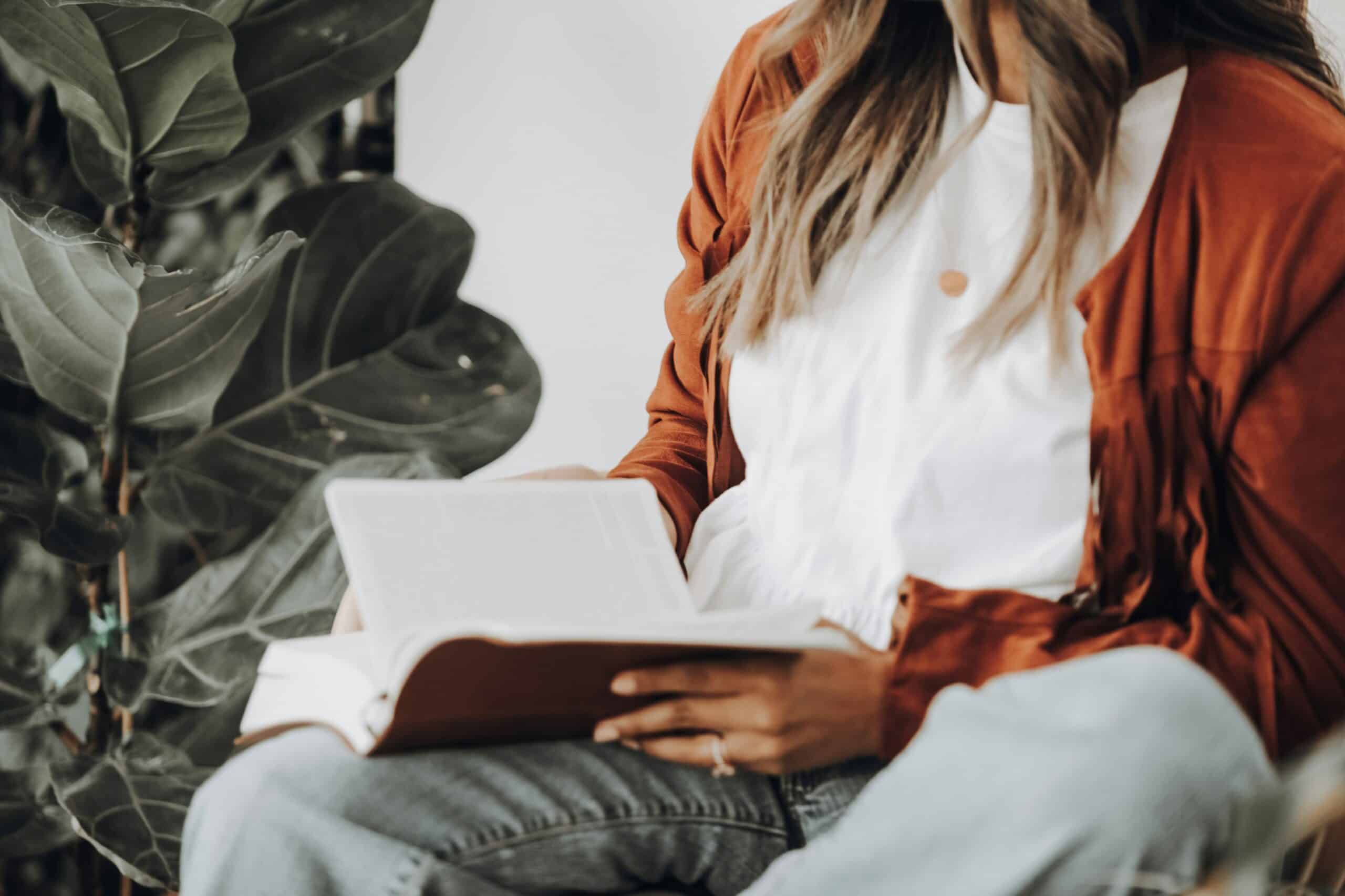 a woman holding a book - Rachael Haverland Site a woman holding a book