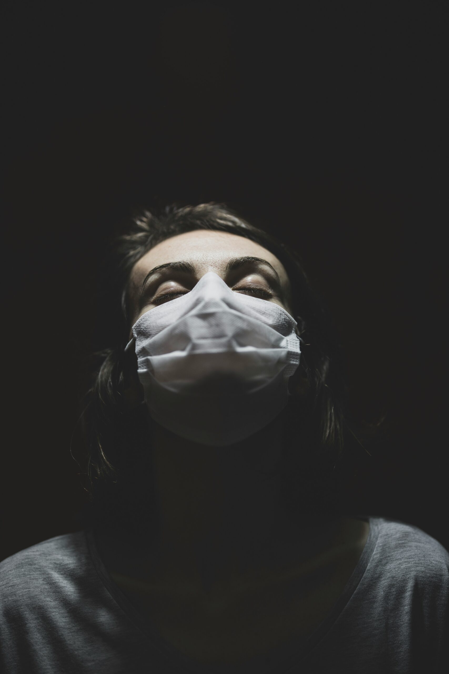 A woman wearing a medical mask reflecting the emotional and physical strain of diagnosing irregular menstruation linked to endometriosis. - Rachael Haverland Site A woman wearing a medical mask reflecting the emotional and physical strain of diagnosing irregular menstruation linked to endometriosis.