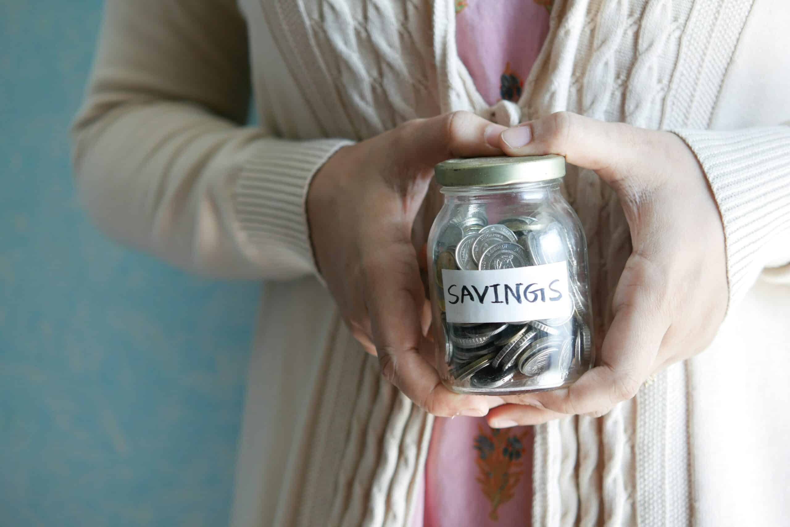 a woman holding a savings jar - Rachael Haverland Site a woman holding a savings jar