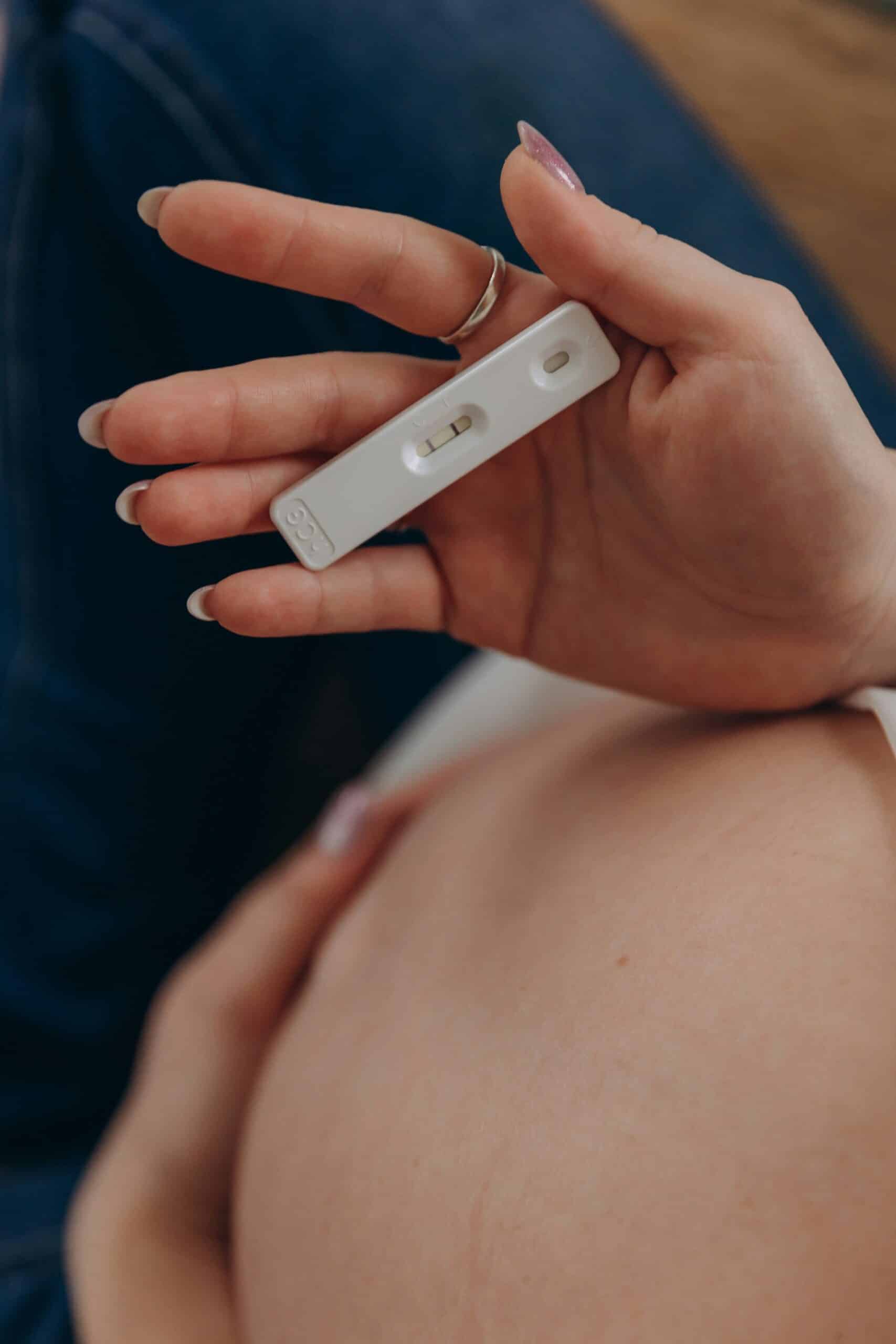 a woman checking her pregnancy test - Rachael Haverland Site a woman checking her pregnancy test