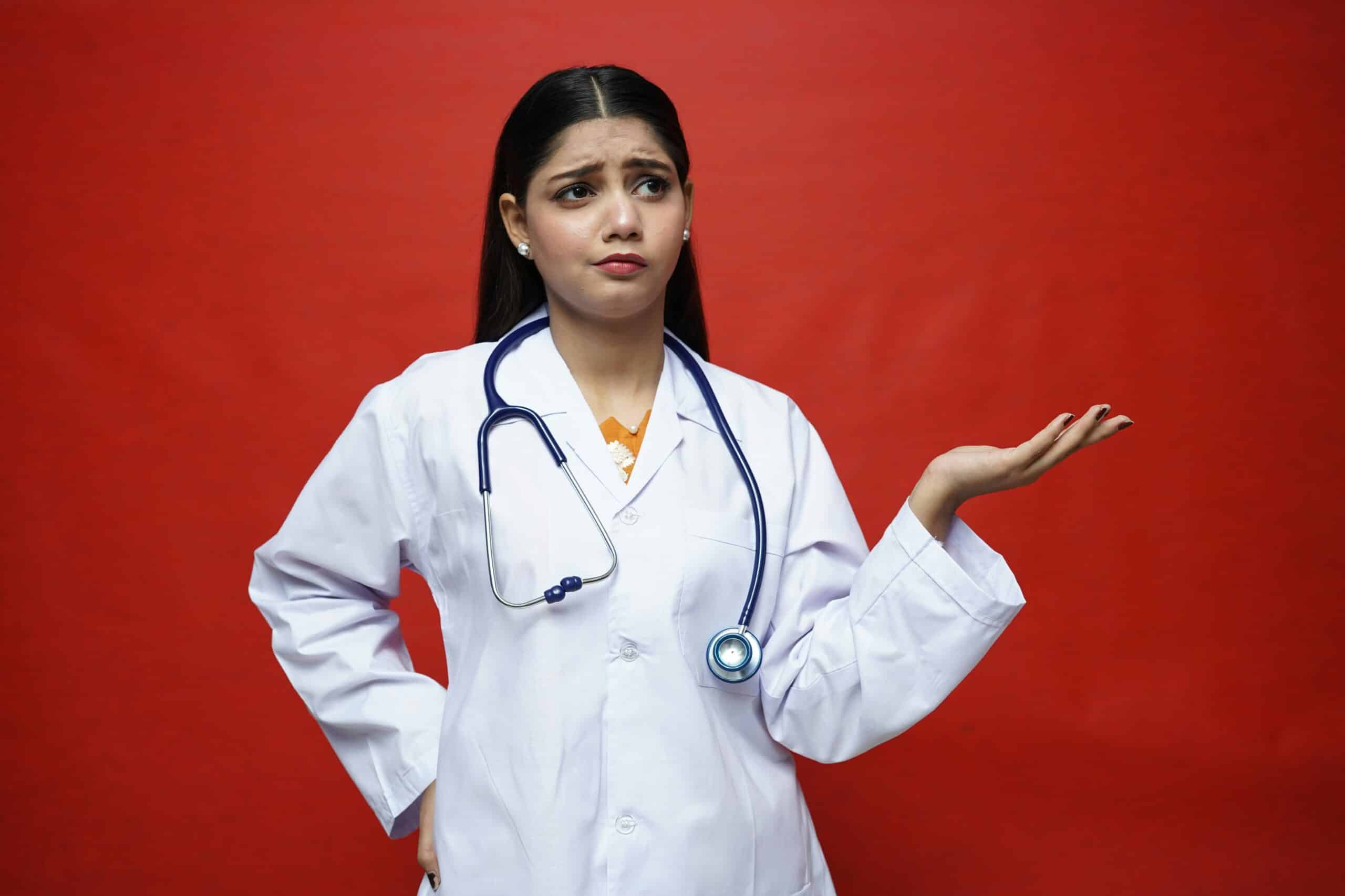 A concerned female doctor gestures with uncertainty, symbolizing the complexity of understanding irregular periods caused by endometriosis. - Rachael Haverland Site A concerned female doctor gestures with uncertainty, symbolizing the complexity of understanding irregular periods caused by endometriosis.