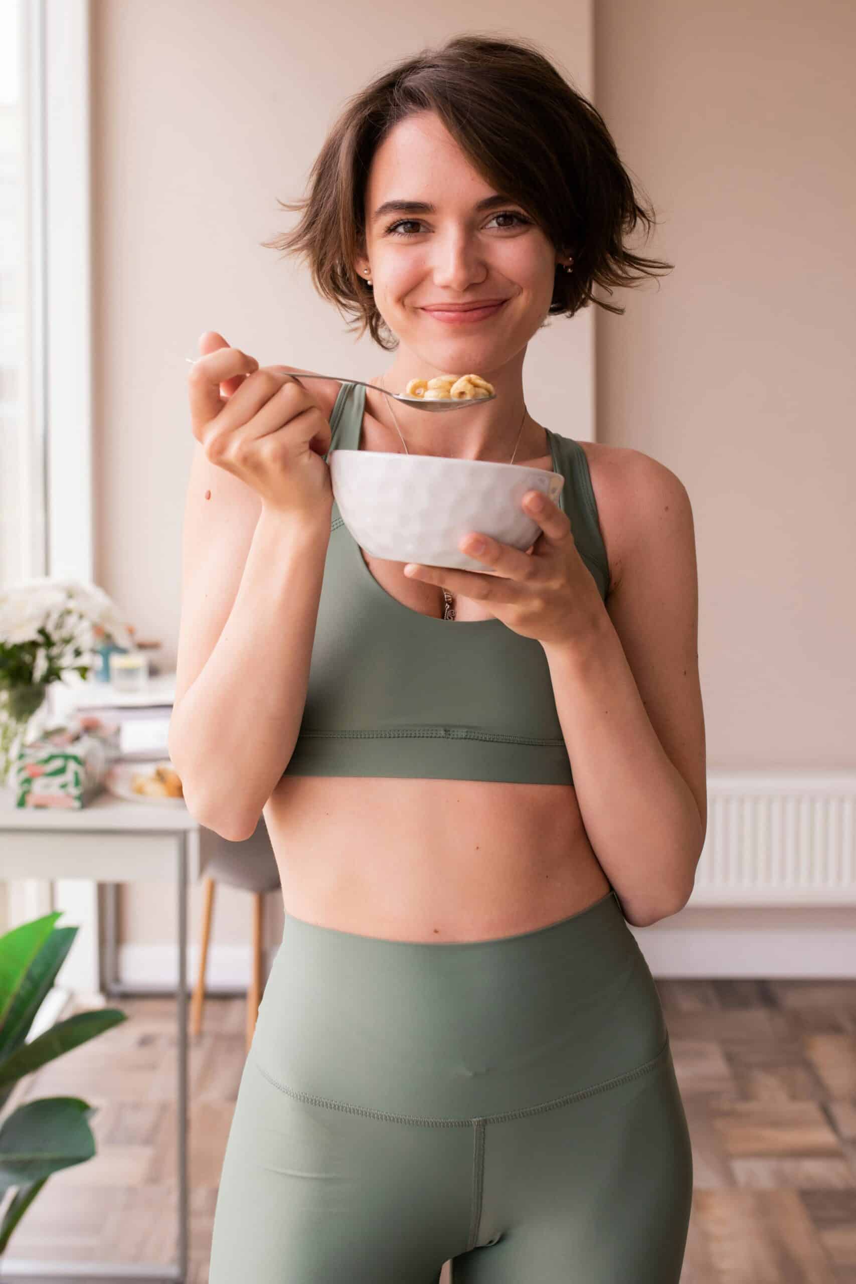 woman in sports wear eating from a bowl - Rachael Haverland Site woman in sports wear eating from a bowl