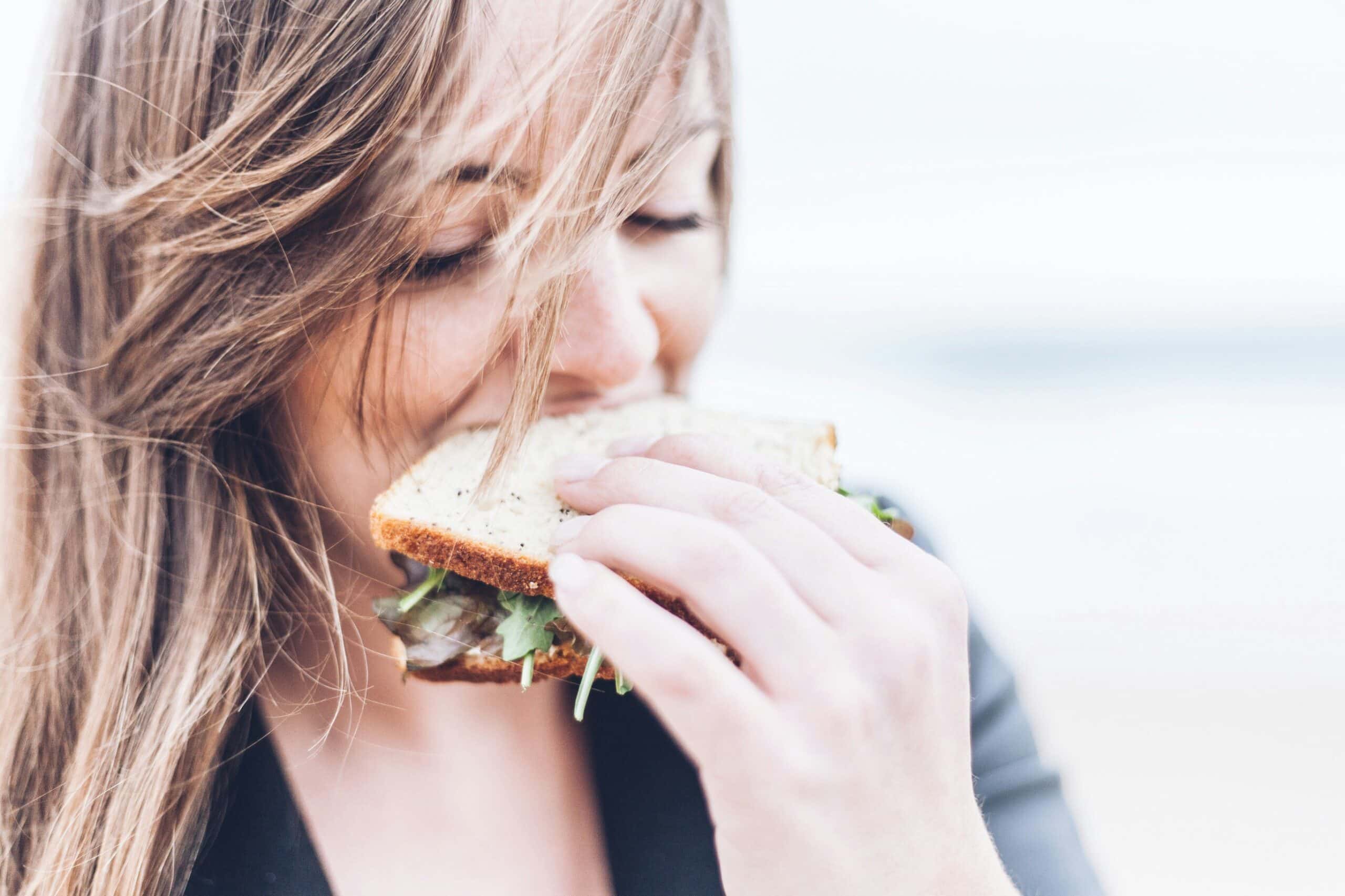 a woman eating a sandwich - Rachael Haverland Site a woman eating a sandwich