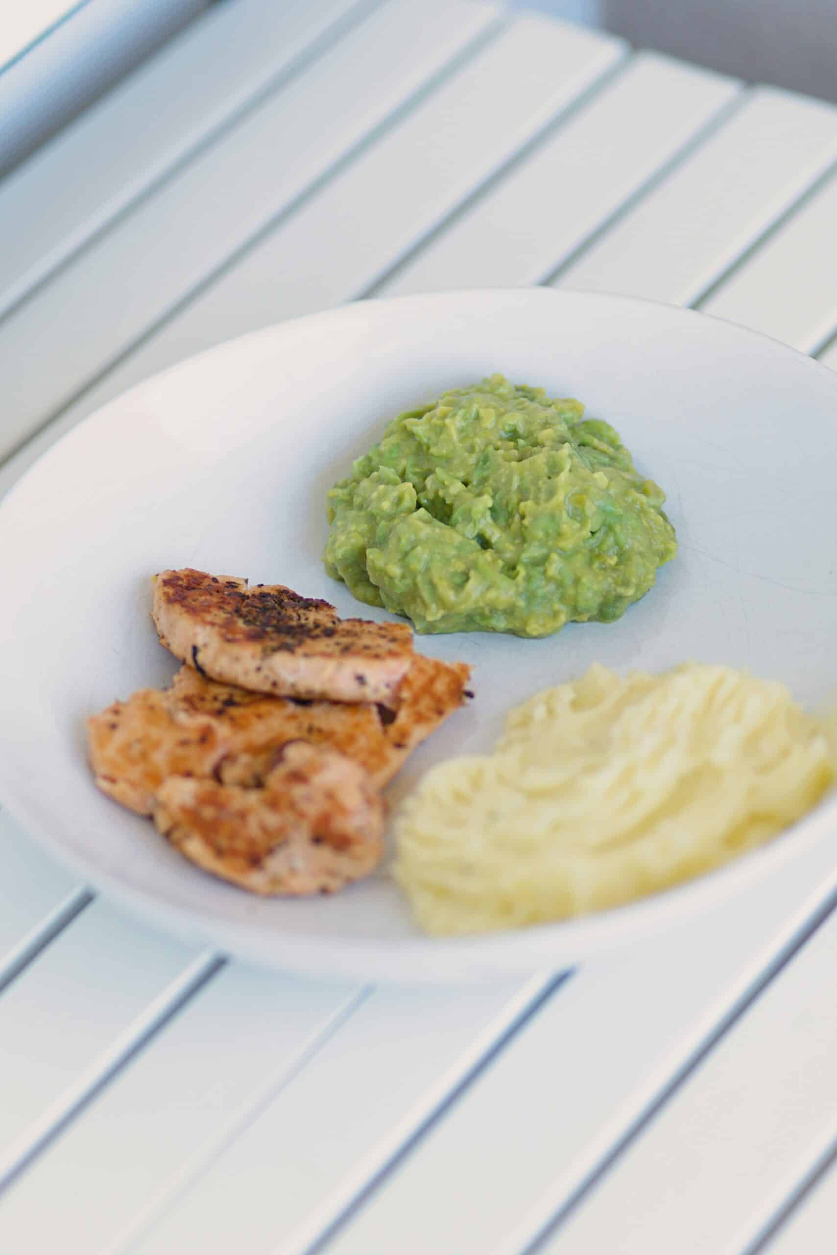 A plate with grilled chicken, mashed potatoes, and guacamole, representing anti-inflammatory food choices suitable for managing endometriosis symptoms. - Rachael Haverland Site Plate of grilled salmon fillets, mashed avocado, and creamy mashed potatoes, emphasizing nutrient-dense foods for an anti-inflammatory diet supporting endometriosis management.