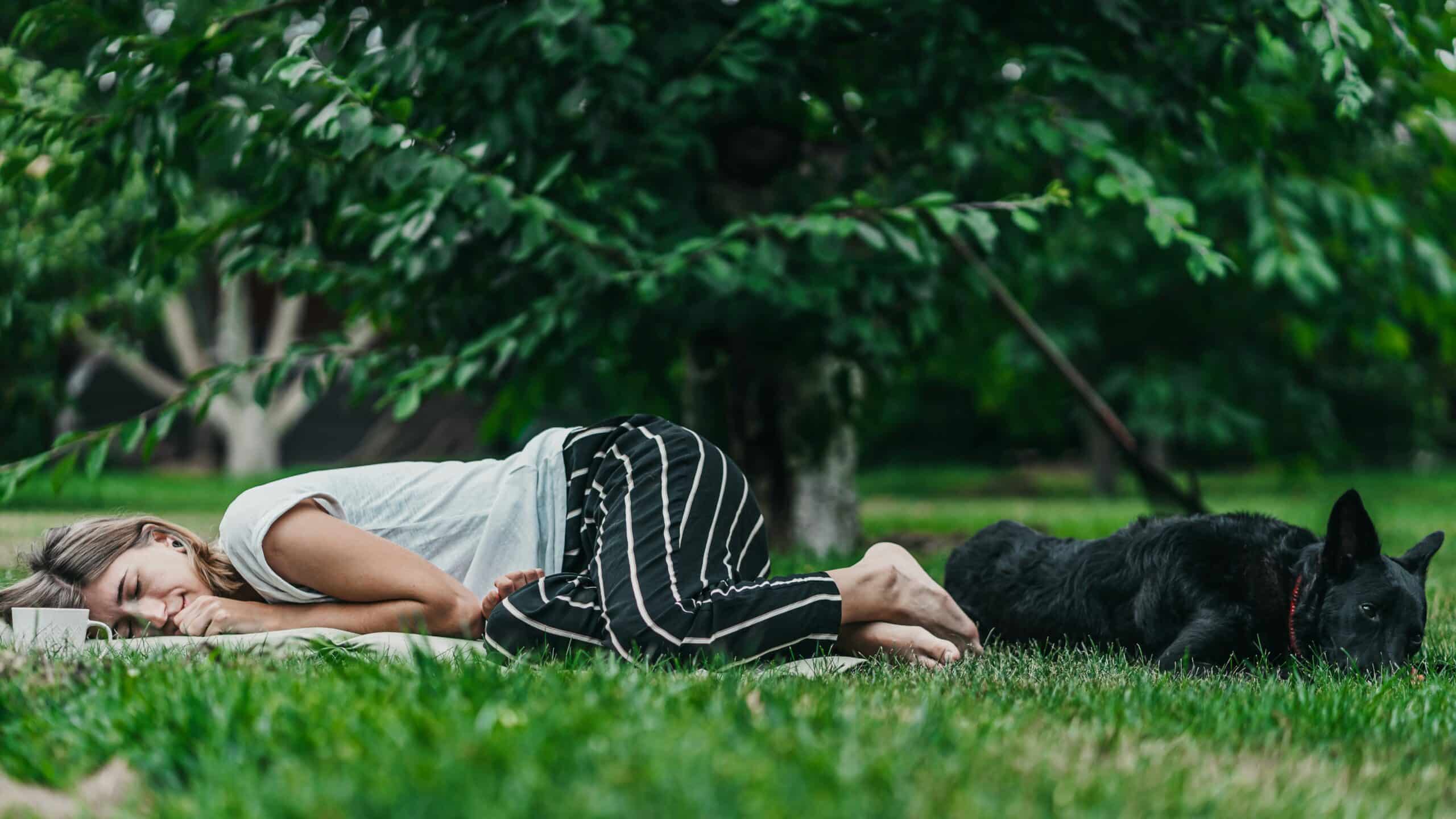 a woman laying on her yoga mat after a yoga session
