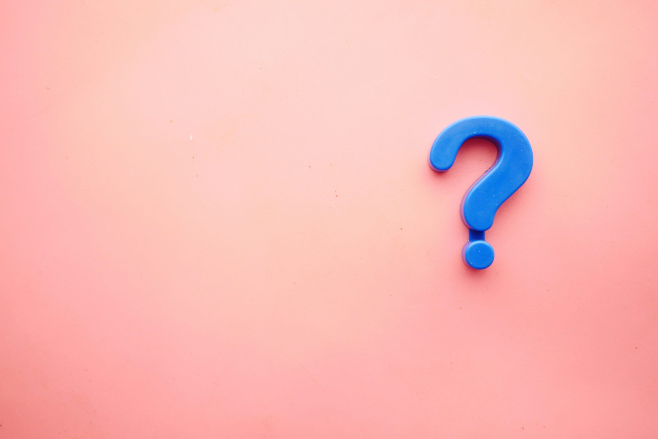 A question mark on a pink background
