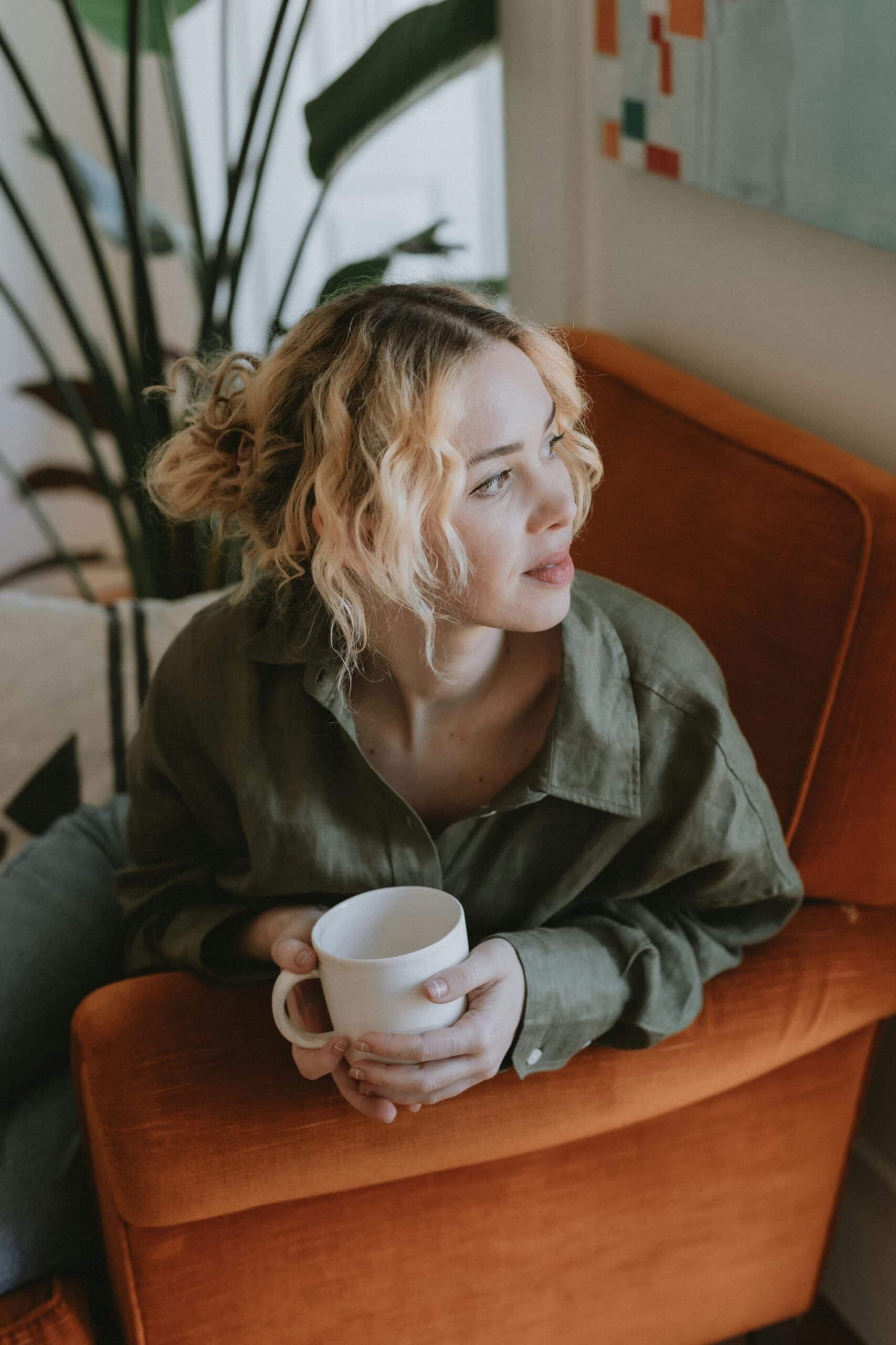 a woman having coffee on the couch