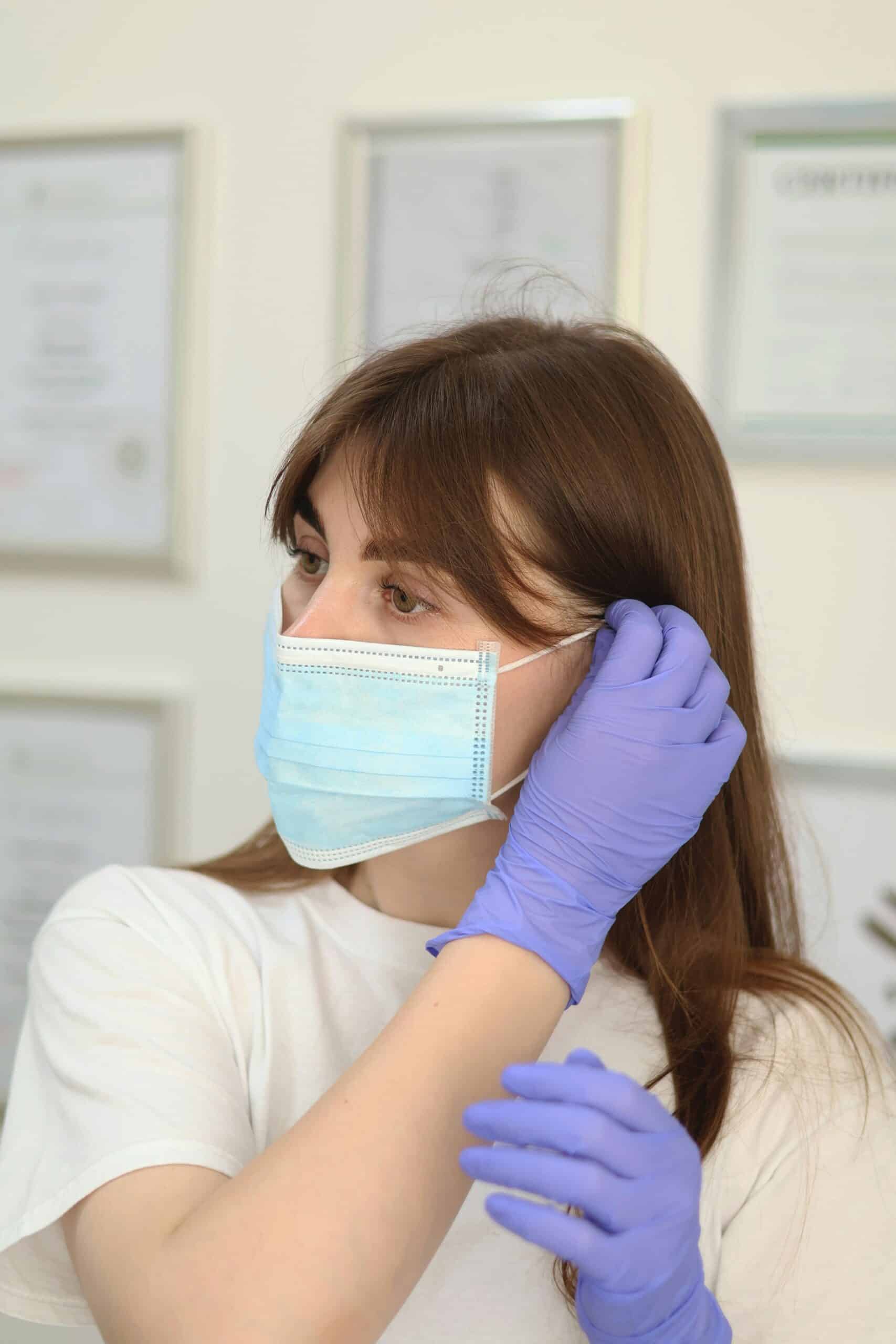 a doctor putting on a mask