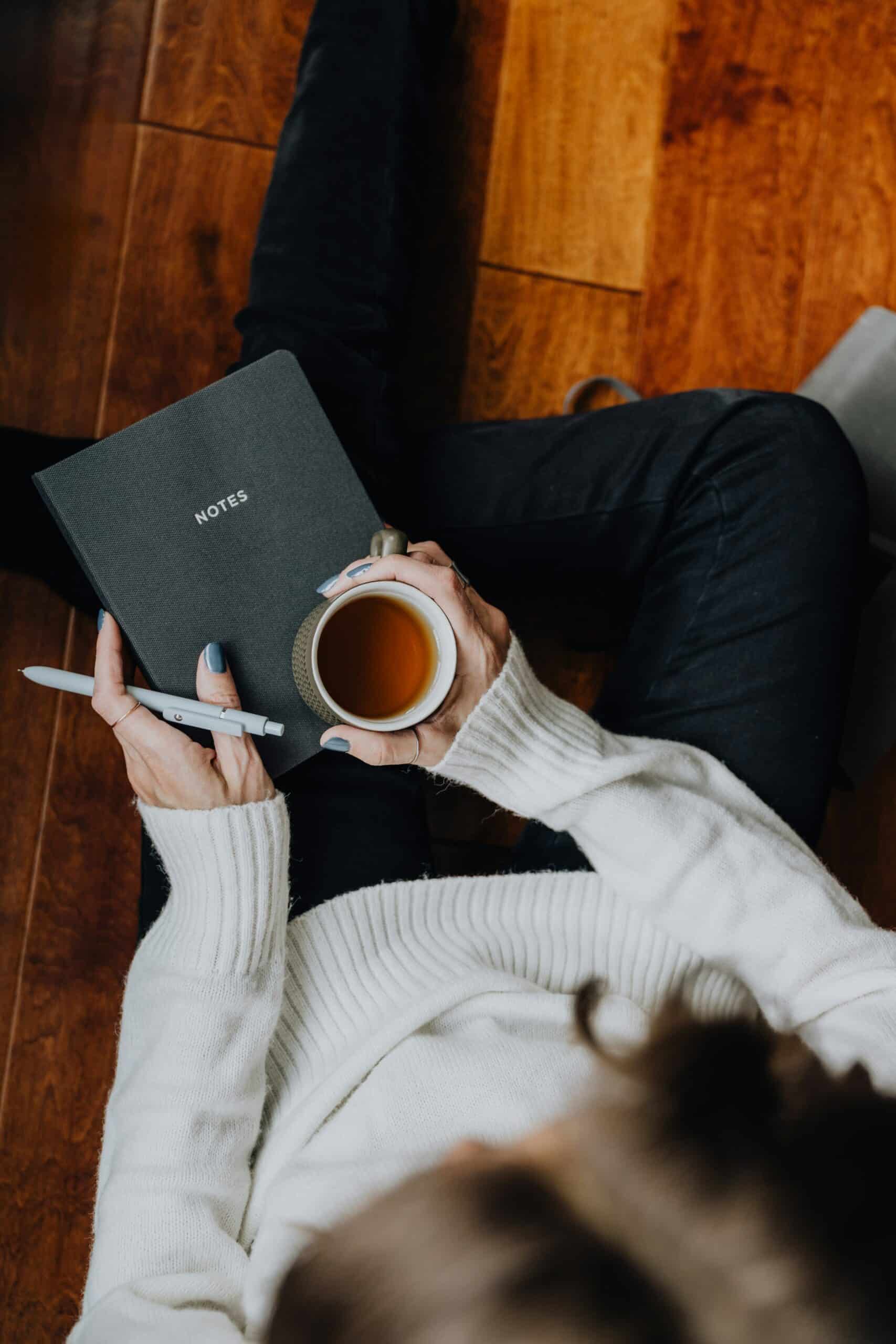 a woman holding a journal - Rachael Haverland Site a woman holding a journal