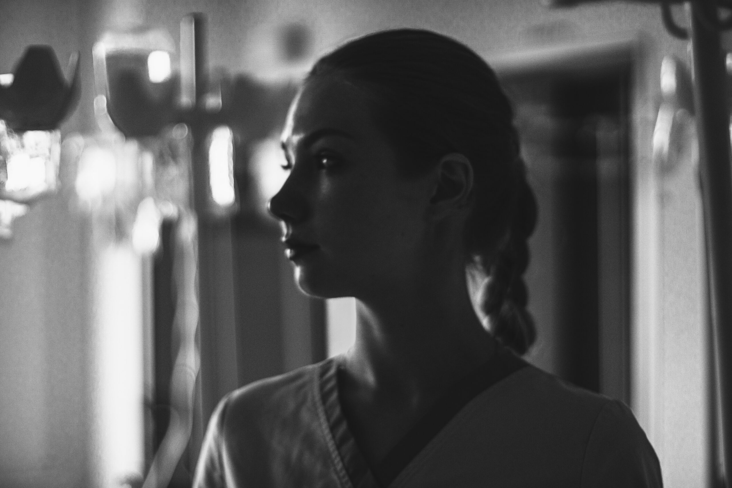 Woman in medical attire, profile view, in a clinical setting, emphasizing care and support for women's health issues like endometriosis.