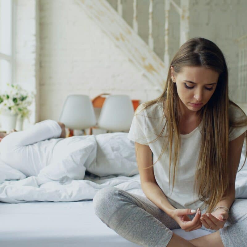 a woman sitting on the bed
