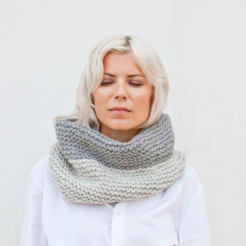 a woman standing with her eyes closed