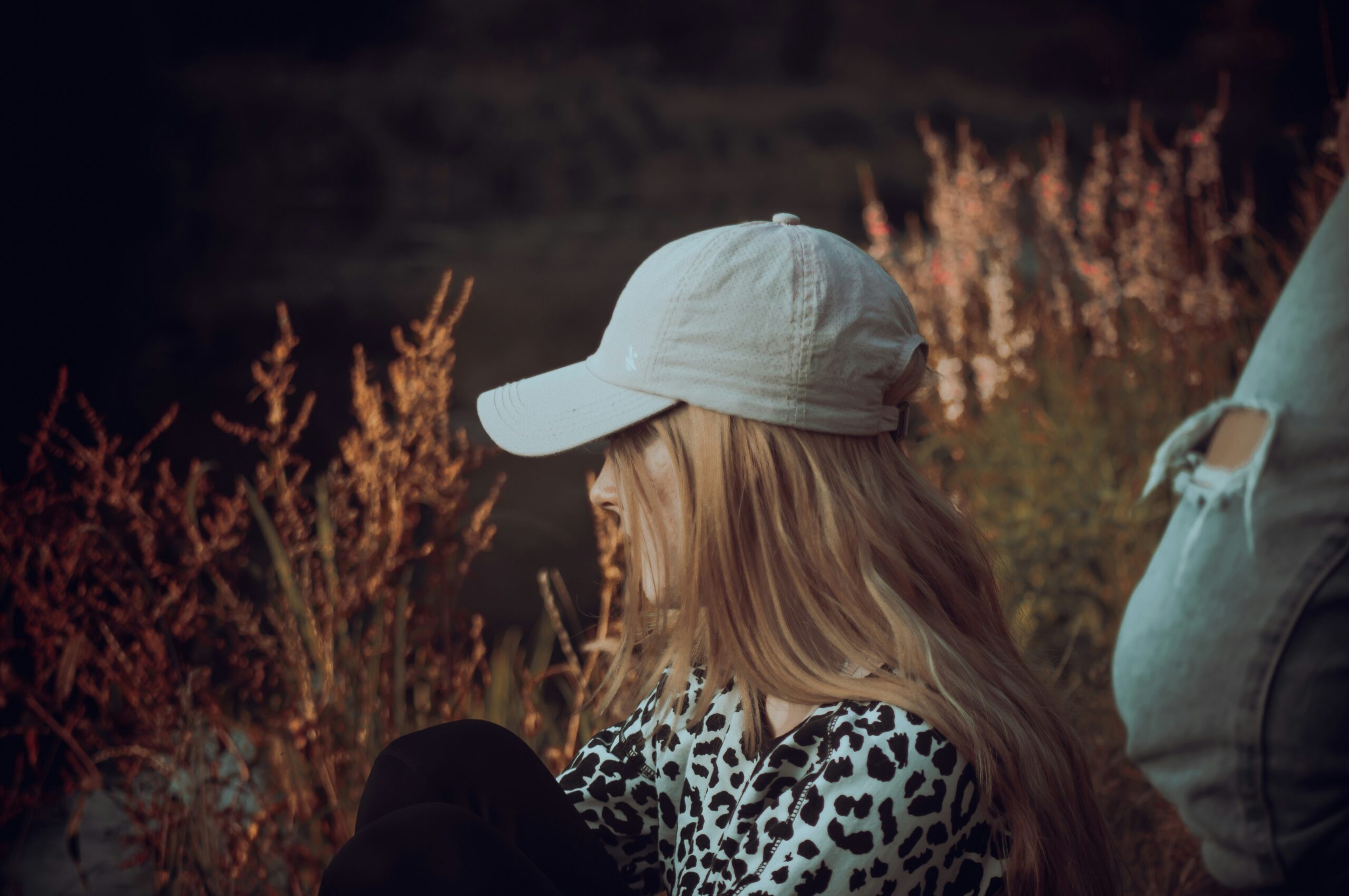 teenage girl sitting in field