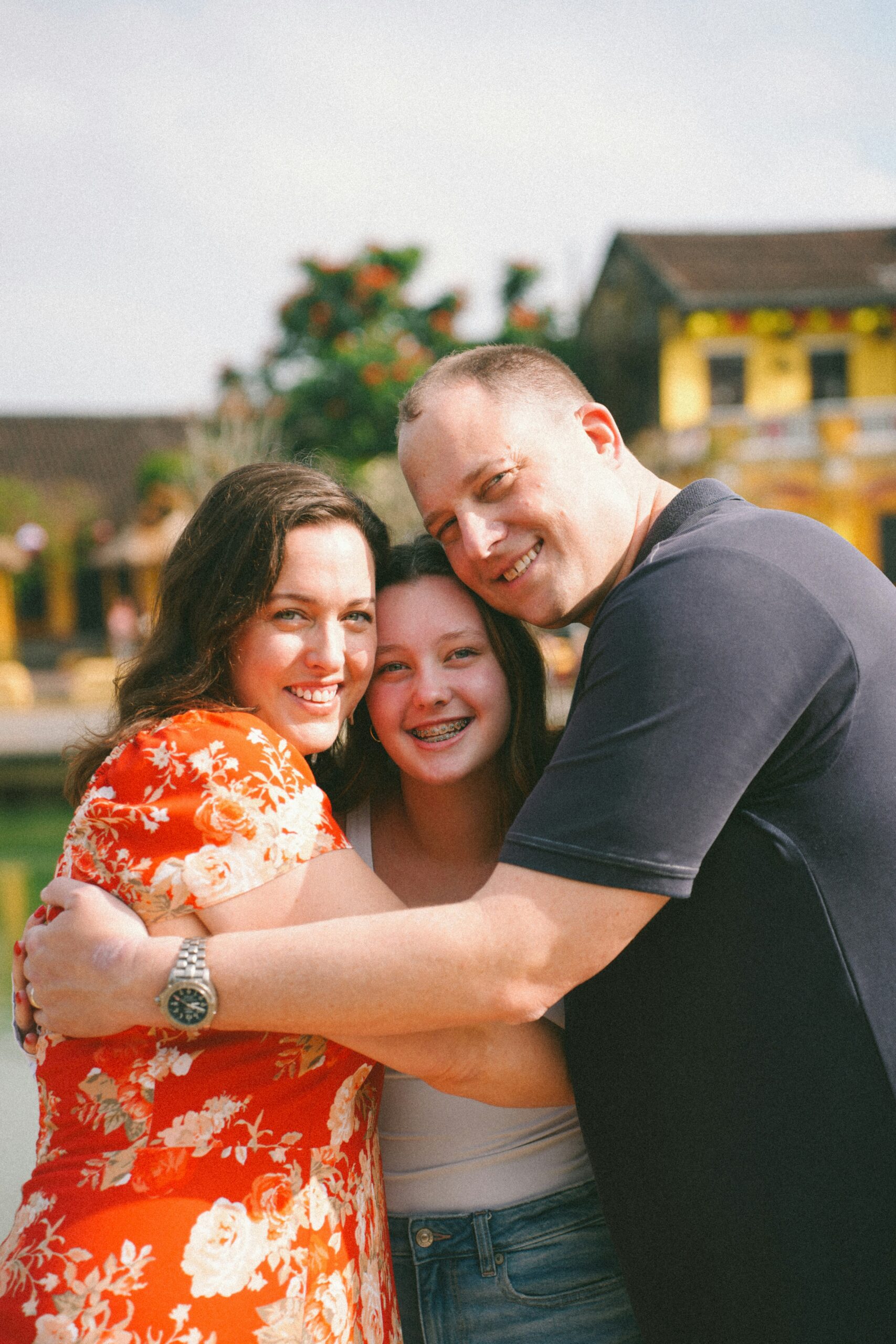 teen girl with parents posing for a photo