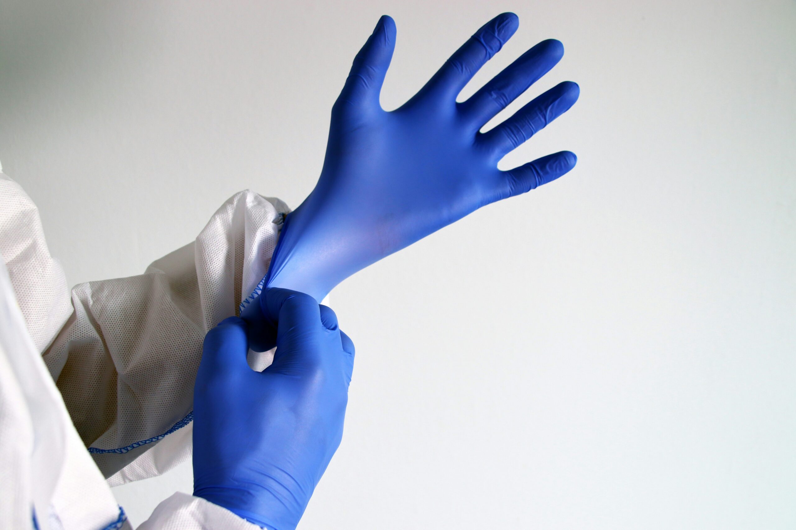preparing for pelvic exam by putting on gloves