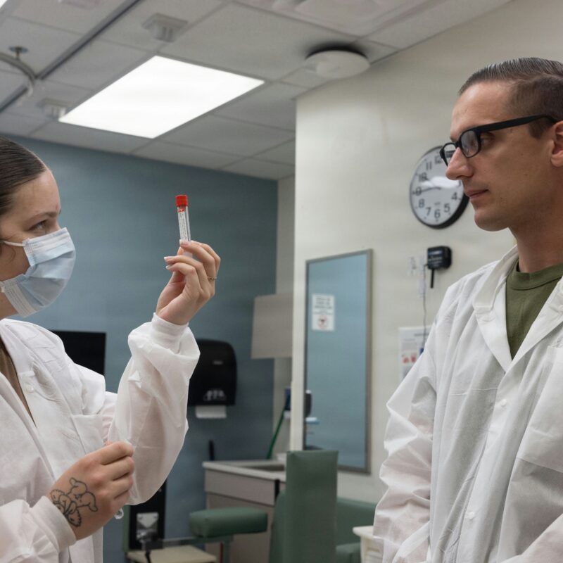 Clinicians examining a medical sample