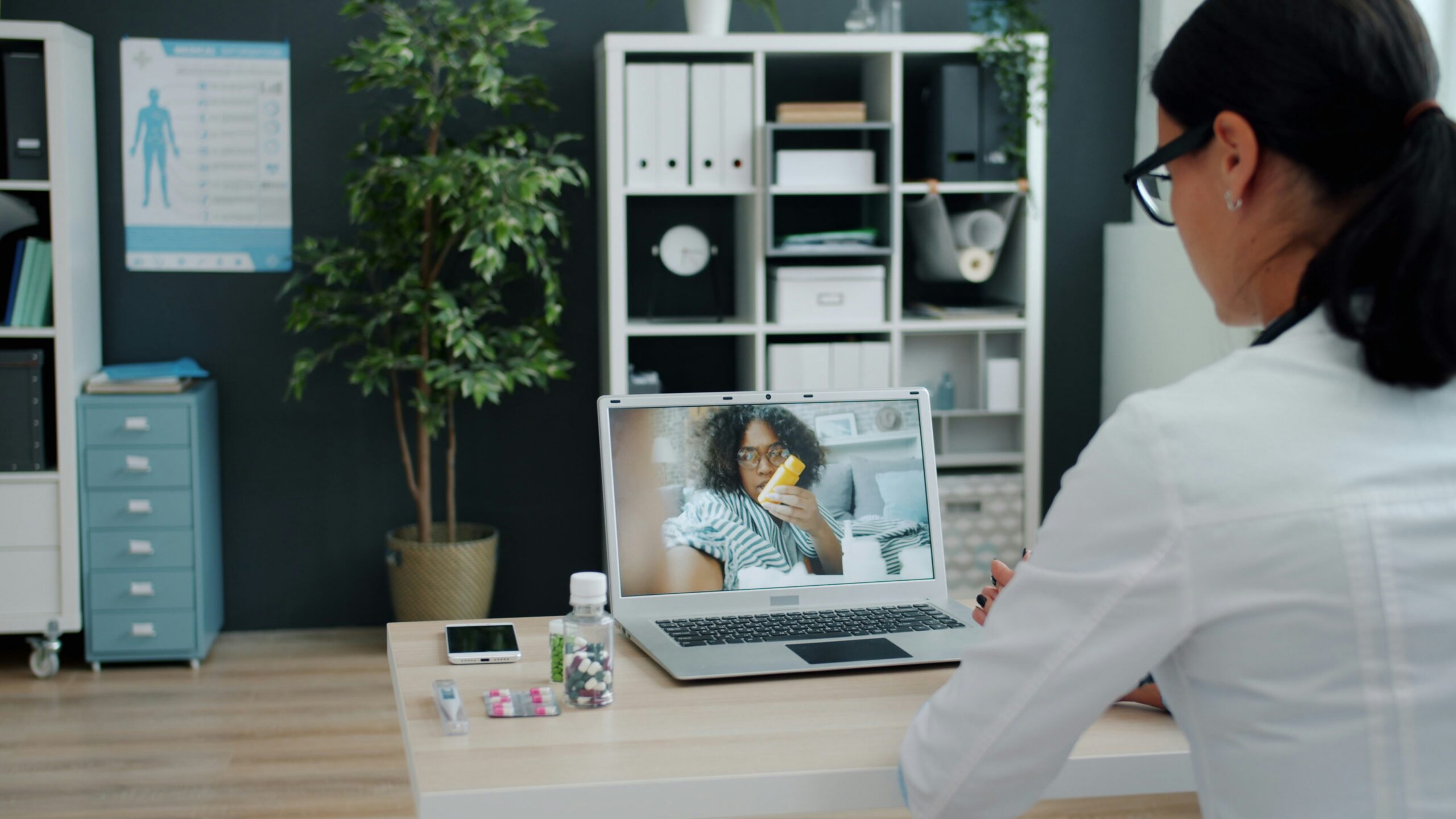 doctor listening to patient on a laptop