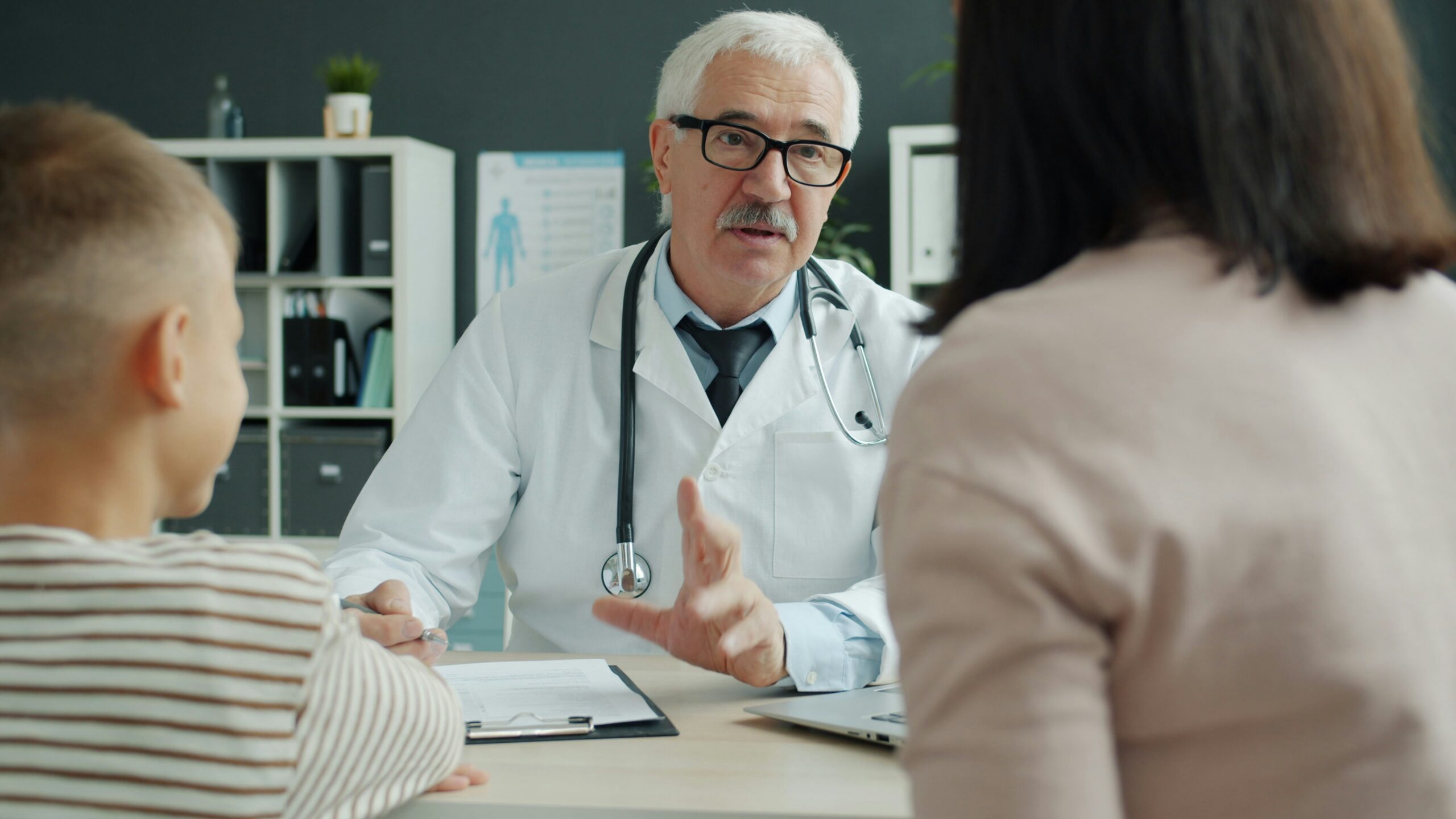 doctor consults with woman with her child