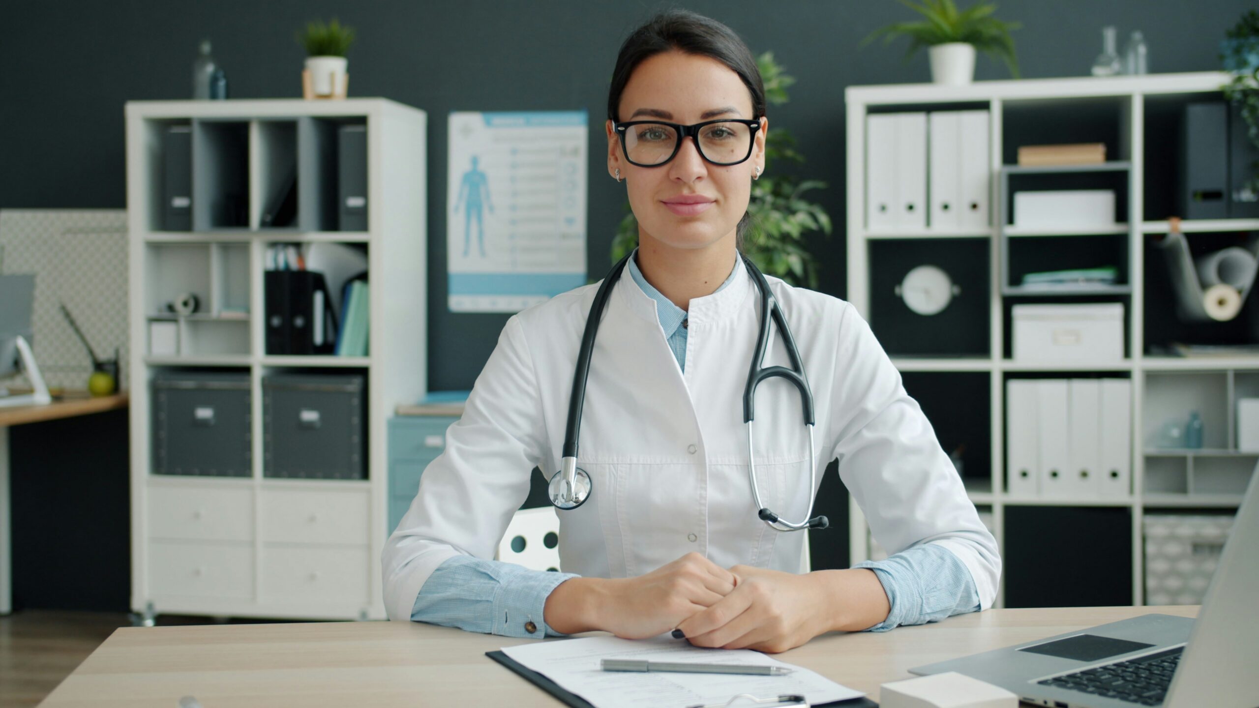 female doctor sits at her desk