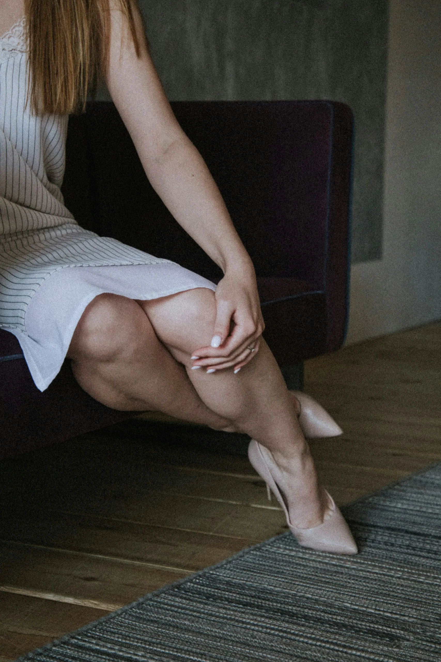 Woman experiencing severe leg pain during her menstrual cycle