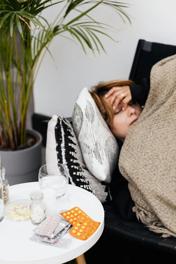 A woman laying in the couch sick