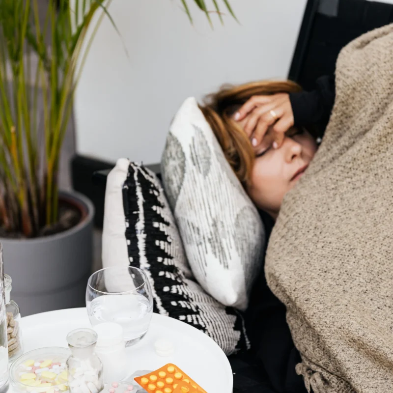 A woman laying in the couch sick