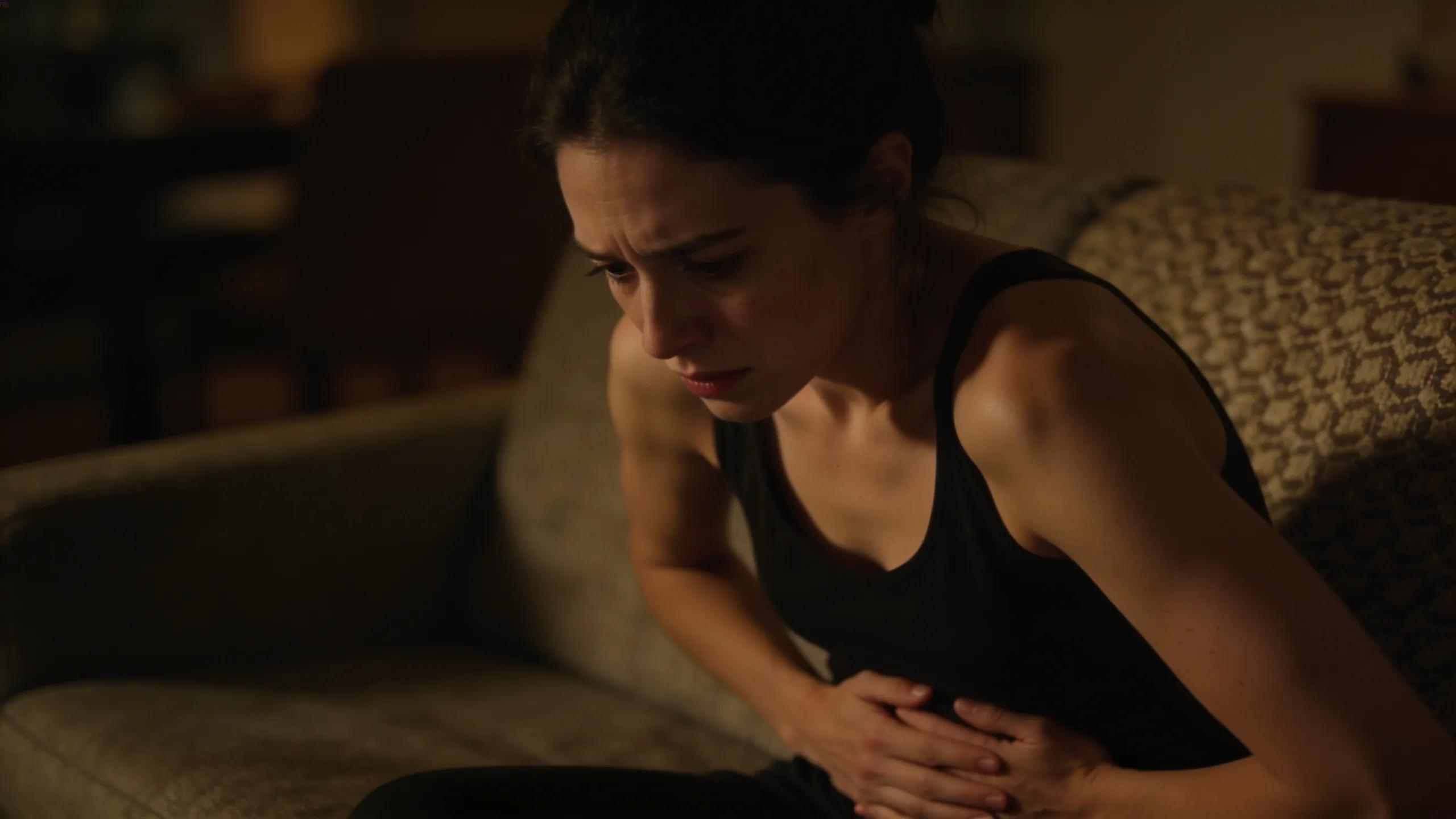 Woman experiencing abdominal discomfort indicative of IBS and bowel endometriosis