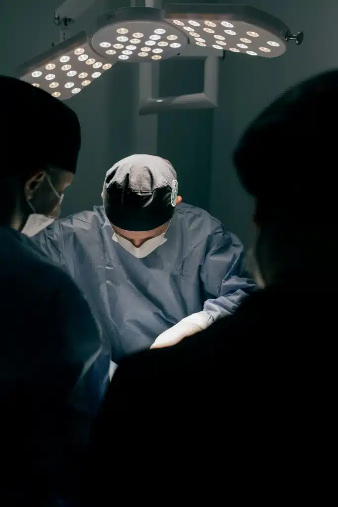 Surgeons performing a surgery in a dark theatre