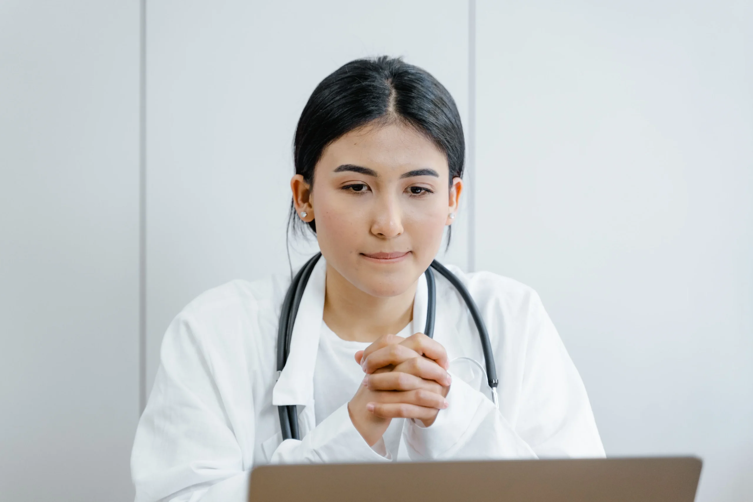 738b7baa c224 4a6a 8b37 35f002556c8dwebp - Rachael Haverland Site A doctor looking at her laptop