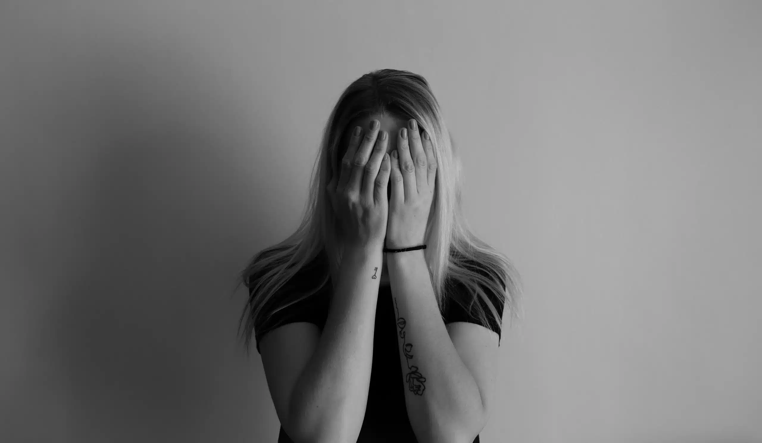 A woman covering her face