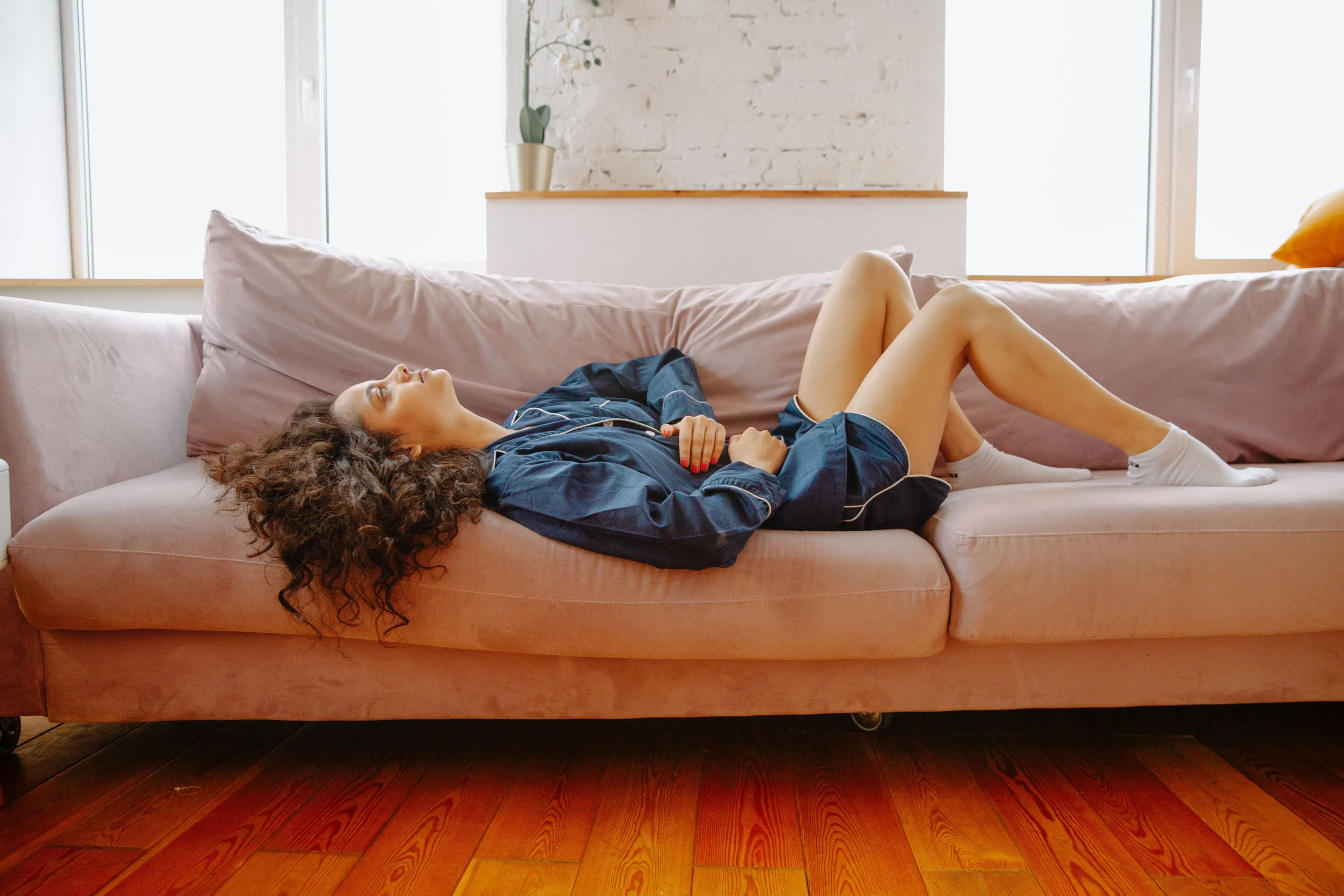 a woman resting on a sofa