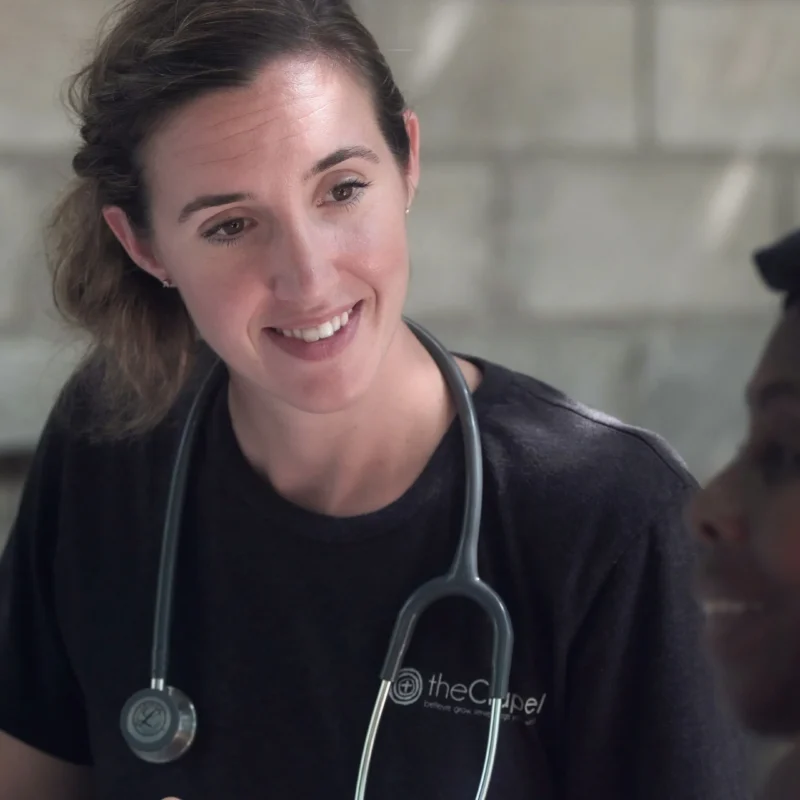 A doctor smiling at a patient